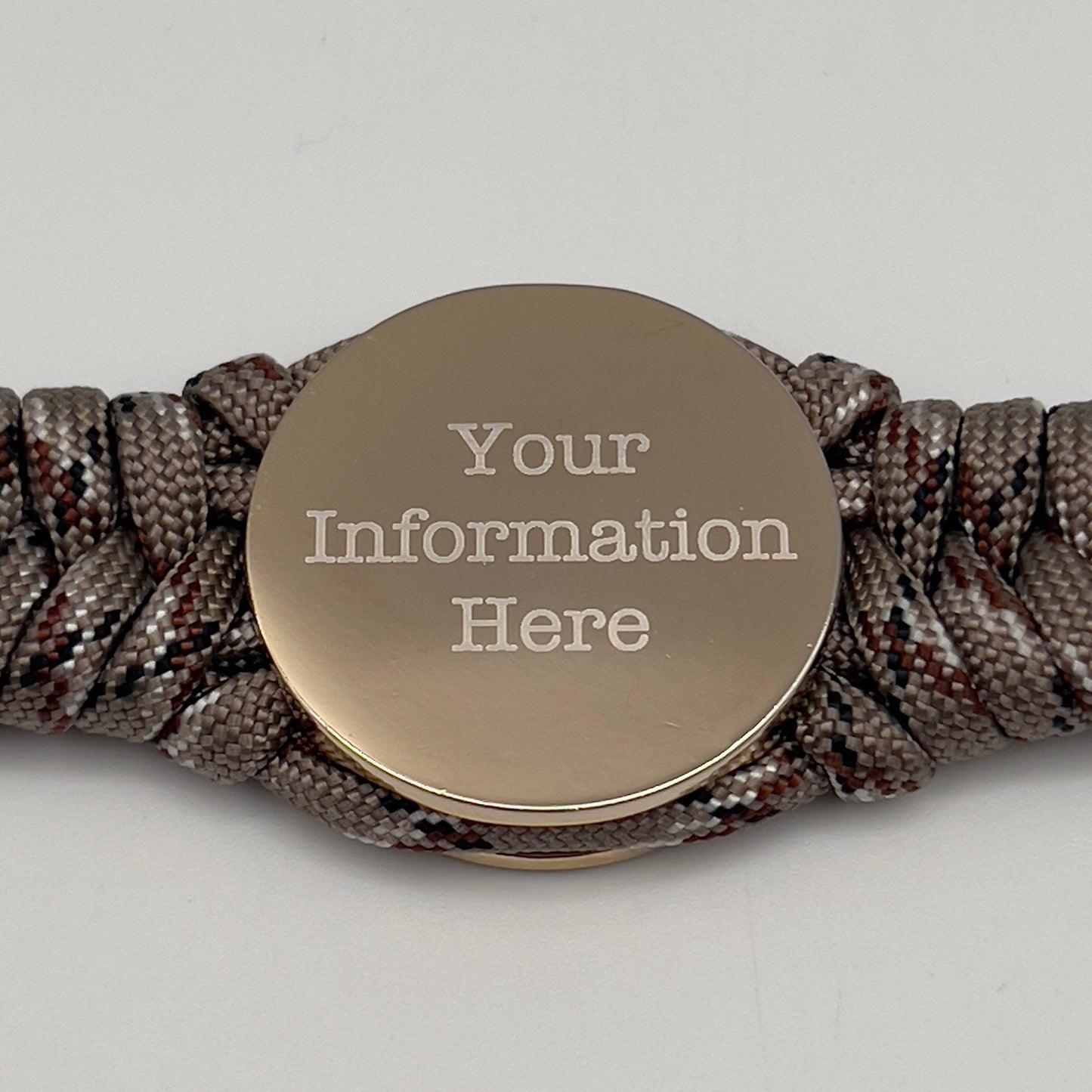 Thick and comfortable braided United States Marine Corps bracelet featuring a 24K gold and silver plated USMC officer Eagle Globe and Anchor medallion, a Cobra style tactical buckle and woven with Desert Camo paracord.