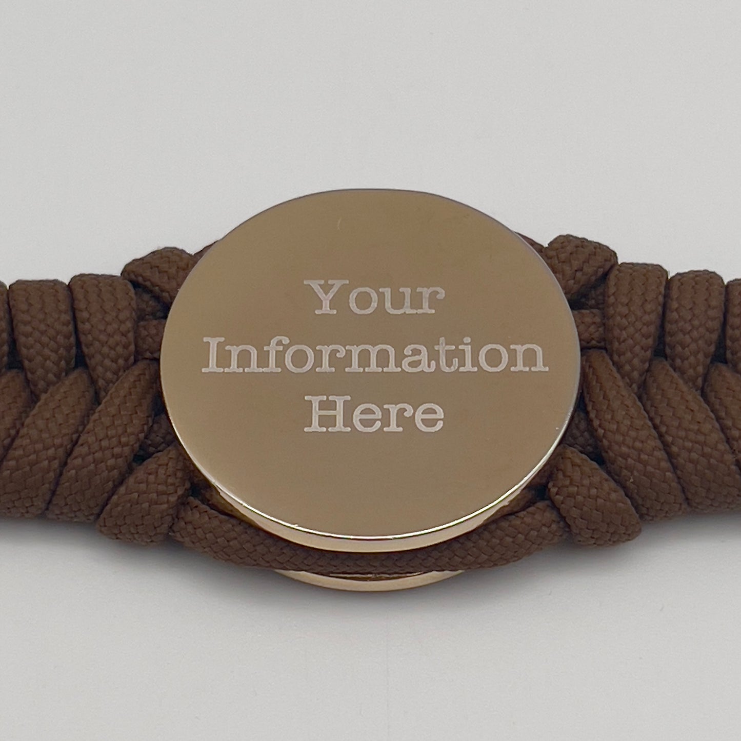 Thick and comfortable braided United States Marine Corps bracelet featuring a 24K gold and silver plated USMC officer Eagle Globe and Anchor medallion, a Cobra style tactical buckle and woven with Coyote brown 550 paracord.