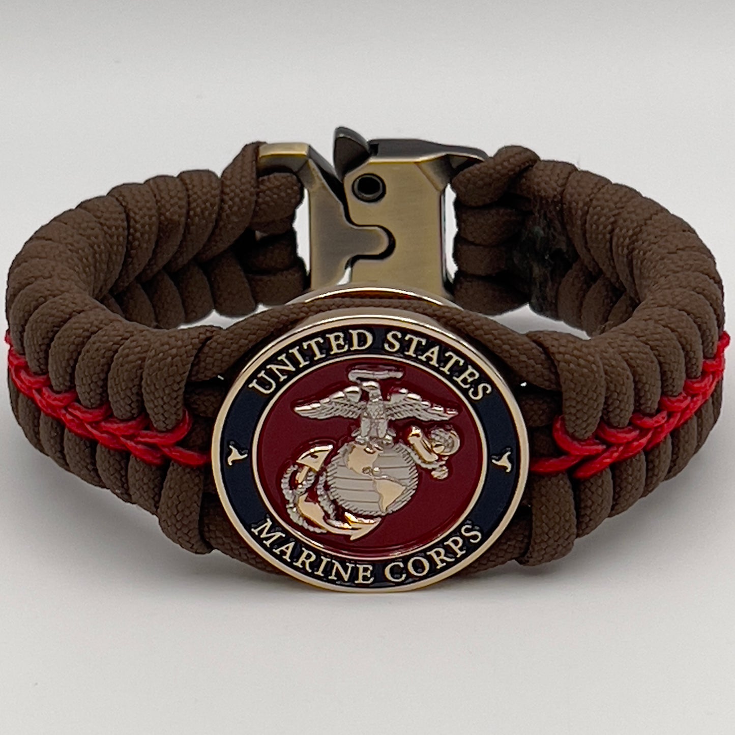 Thick, semi-rigid and comfortable braided United States Marine Corps bracelet featuring a 24K gold and silver plated USMC officer Eagle Globe and Anchor medallion, a Cobra style tactical buckle and woven with Coyote brown 550 and Imperial red micro paracord.