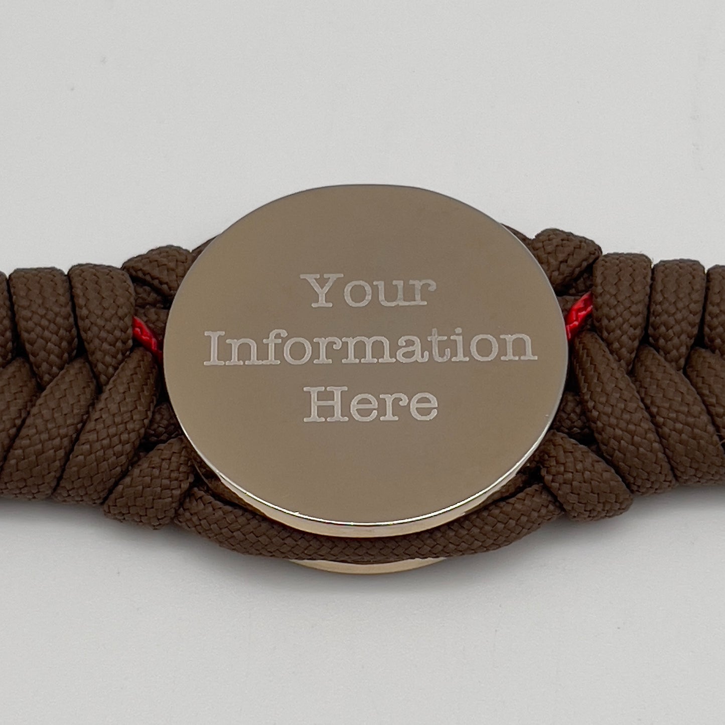 Thick, semi-rigid and comfortable braided United States Marine Corps bracelet featuring a 24K gold and silver plated USMC officer Eagle Globe and Anchor medallion, a Cobra style tactical buckle and woven with Coyote brown 550 and Imperial red micro paracord.