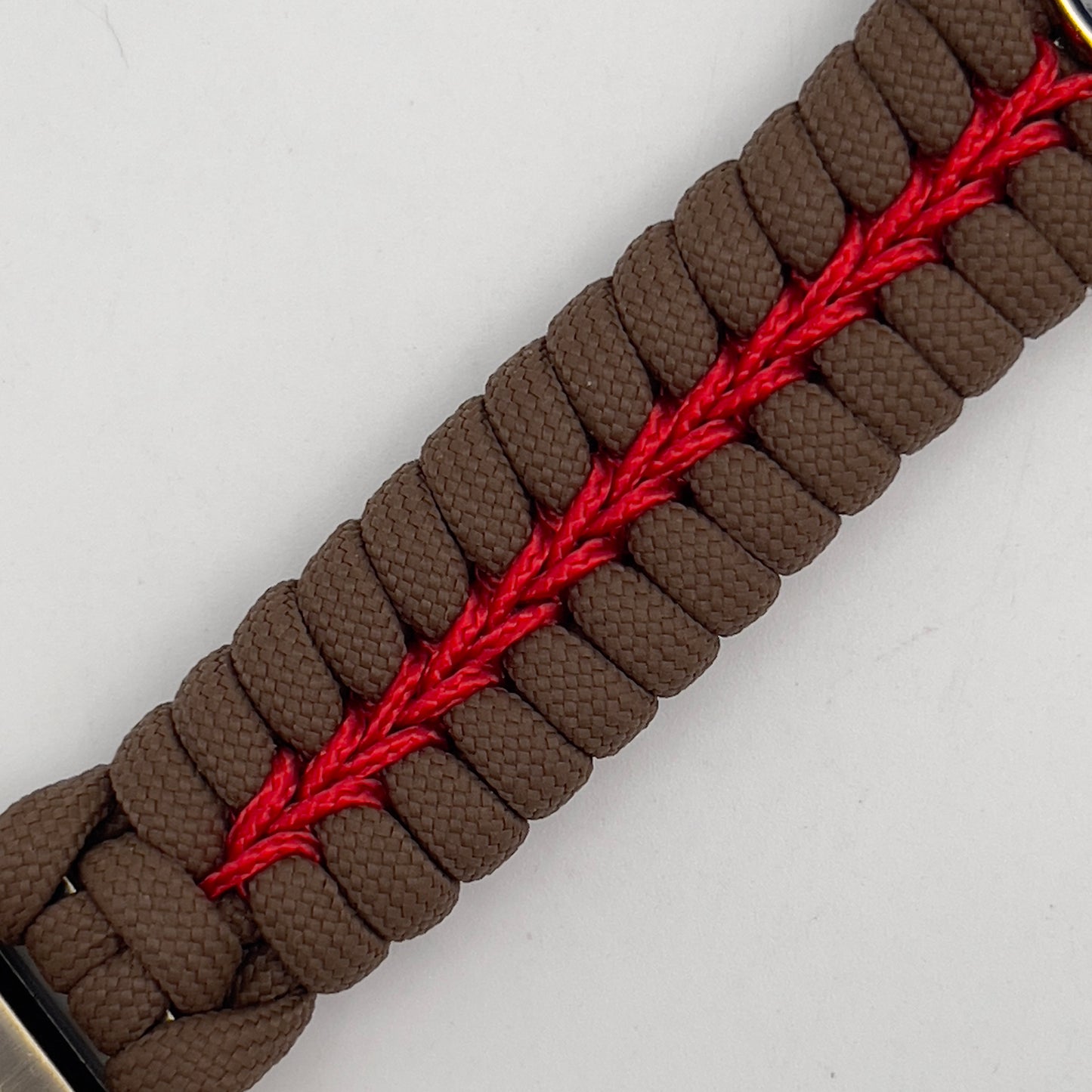 Thick, semi-rigid and comfortable braided United States Marine Corps bracelet featuring a 24K gold and silver plated USMC officer Eagle Globe and Anchor medallion, a Cobra style tactical buckle and woven with Coyote brown 550 and Imperial red micro paracord.