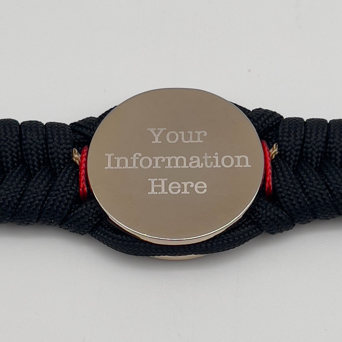 Thick, semi-rigid and comfortable braided United States Marine Corps bracelet featuring a 24K gold and silver plated USMC officer Eagle Globe and Anchor medallion, a black Cobra style tactical buckle and woven with black 550, Imperial red and gold micro paracord.