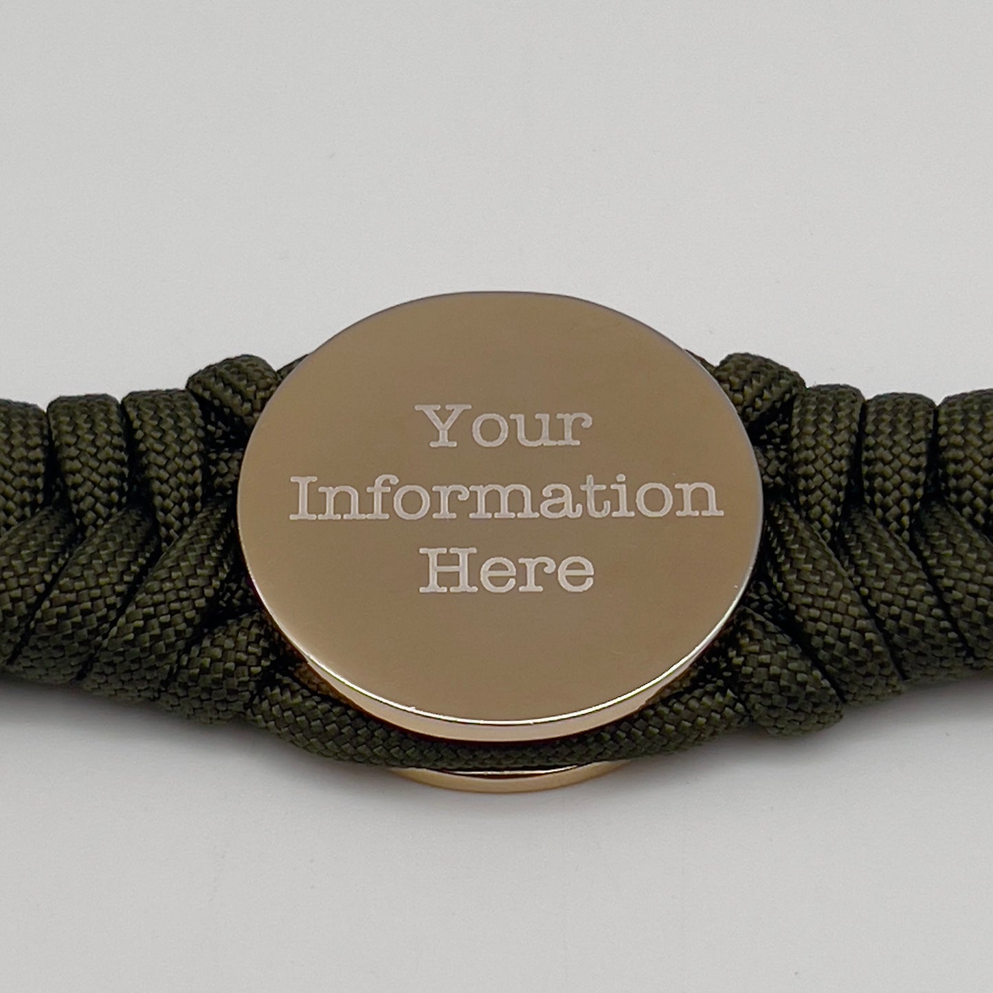 Thick, semi-rigid and comfortable braided United States Marine Corps bracelet featuring a 24K gold and silver plated USMC officer Eagle Globe and Anchor medallion, a gold Cobra style tactical buckle and woven with olive drab 550 paracord.