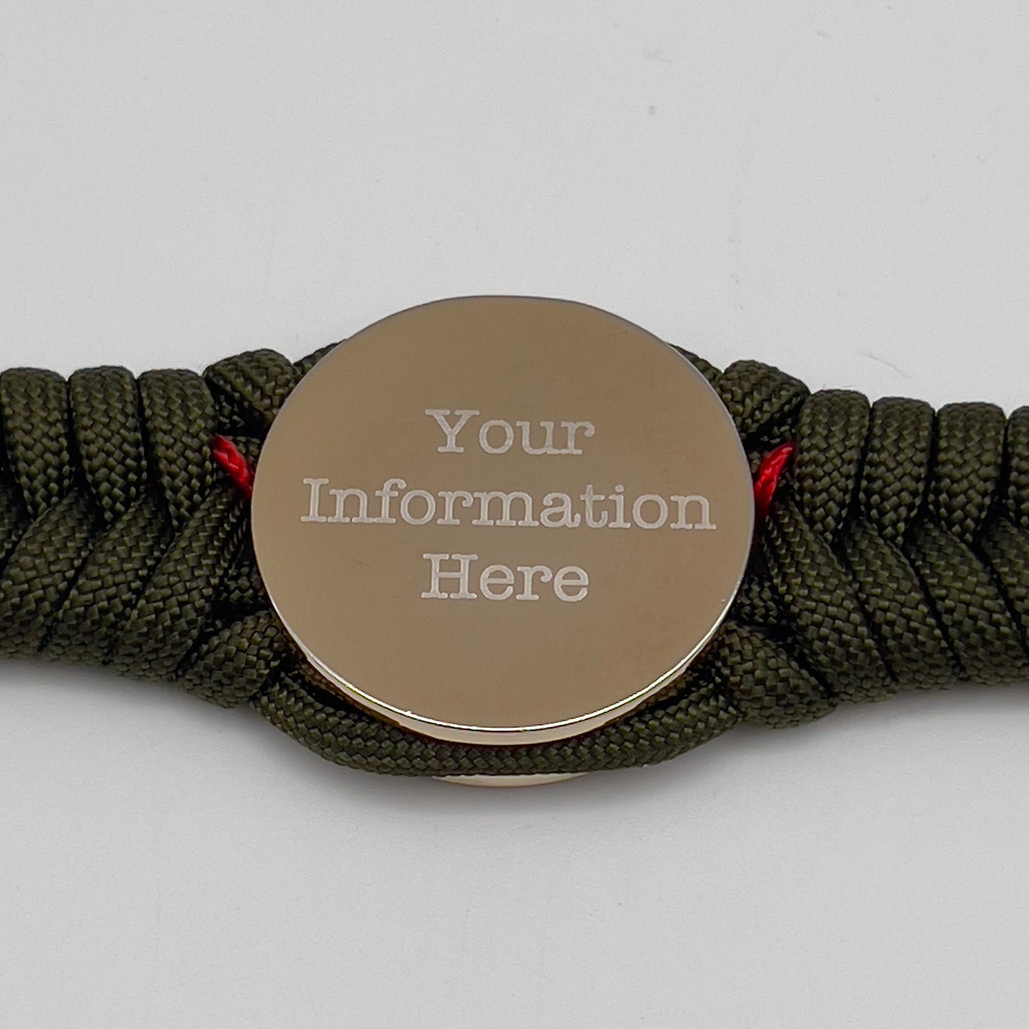 Thick, semi-rigid and comfortable braided United States Marine Corps bracelet featuring a 24K gold and silver plated USMC officer Eagle Globe and Anchor medallion, a gold Cobra style tactical buckle and woven with olive drab 550 and Imperial red micro paracord.