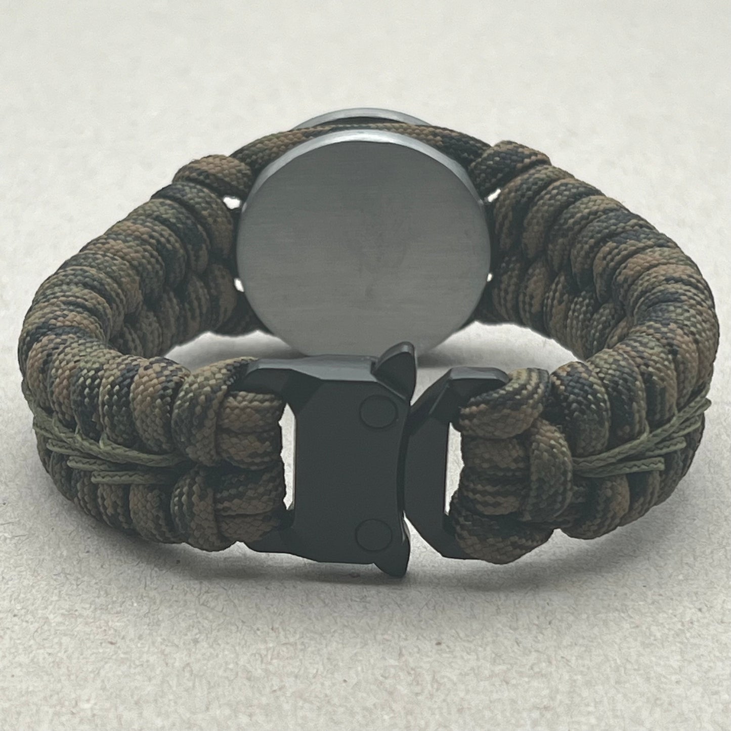 Thick, narrow, rigid and comfortable braided United States Army bracelet featuring an antique silver plated baked enamel hand painted US Army medallion, a black Cobra style tactical buckle and woven with Woodland Camo 550 paracord and Olive Drab micro cord.