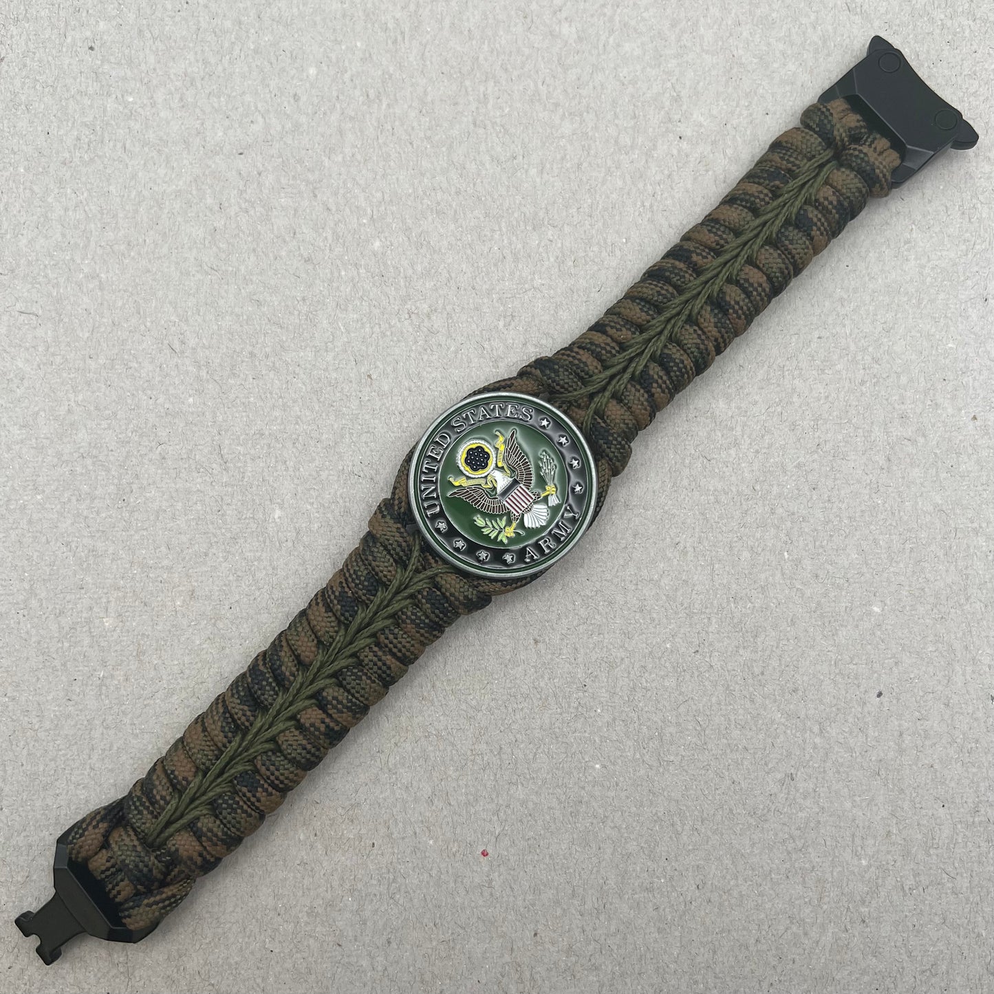 Thick, narrow, rigid and comfortable braided United States Army bracelet featuring an antique silver plated baked enamel hand painted US Army medallion, a black Cobra style tactical buckle and woven with Woodland Camo 550 paracord and Olive Drab micro cord.