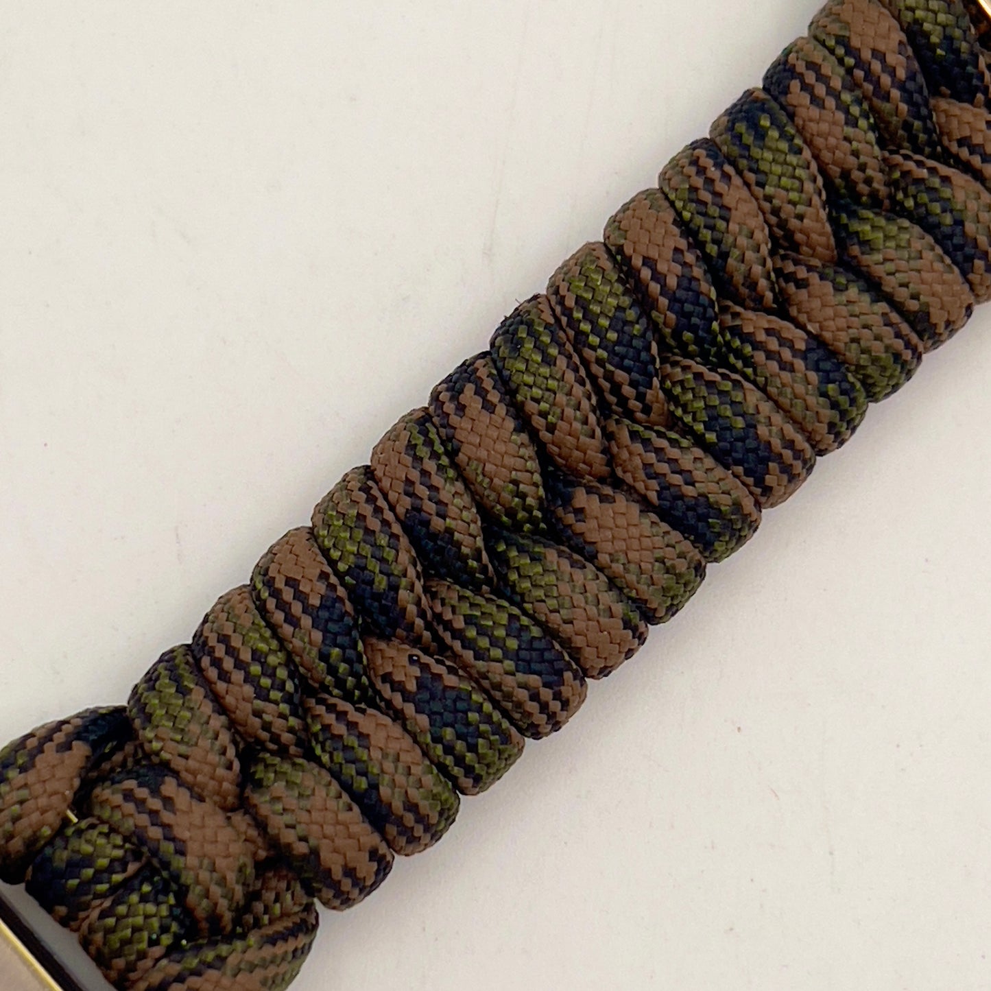 Thick, semi-rigid and comfortable braided United States Marine Corps bracelet featuring a 24K gold and silver plated USMC officer Eagle Globe and Anchor medallion, a gold Cobra style tactical buckle and woven with Woodland Camo 550 paracord.
