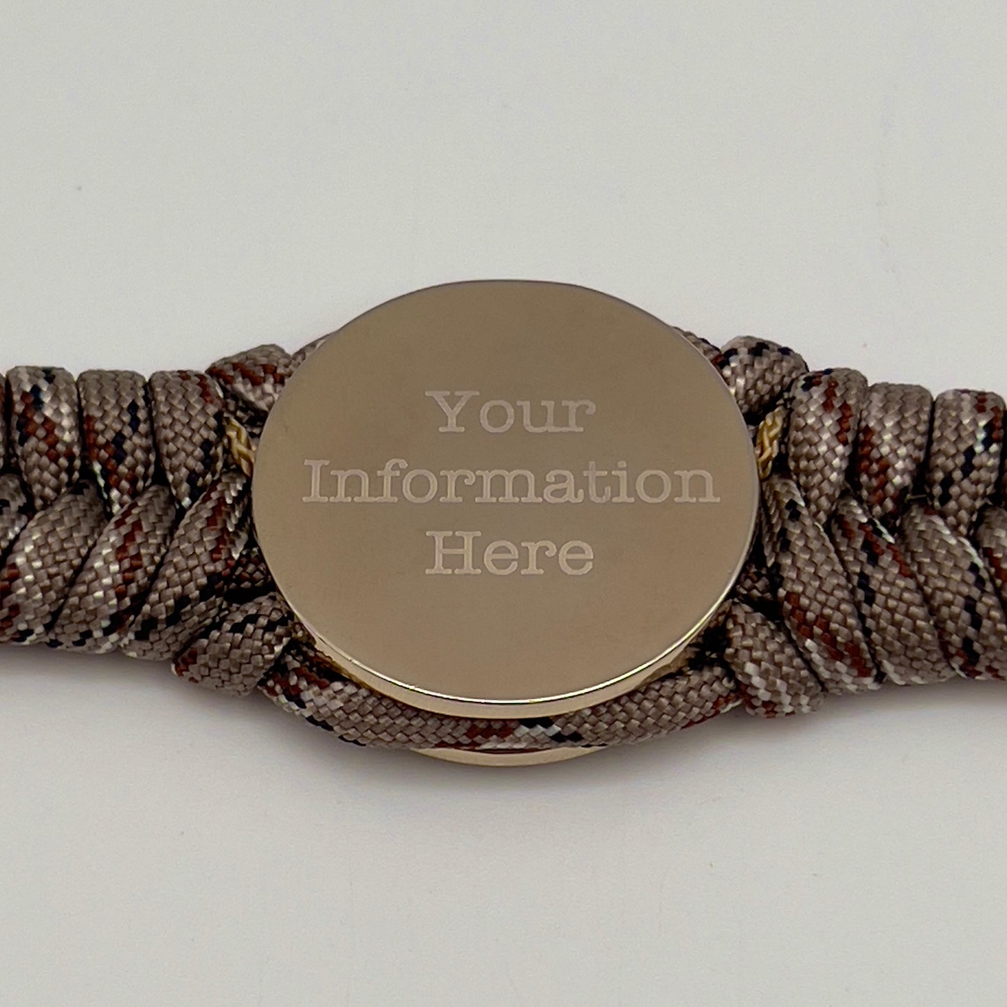 Thick and comfortable braided United States Marine Corps bracelet featuring a 24K gold and silver plated USMC officer Eagle Globe and Anchor medallion, a Cobra style tactical buckle and woven with Desert Camo 550 paracord gold micro cord.