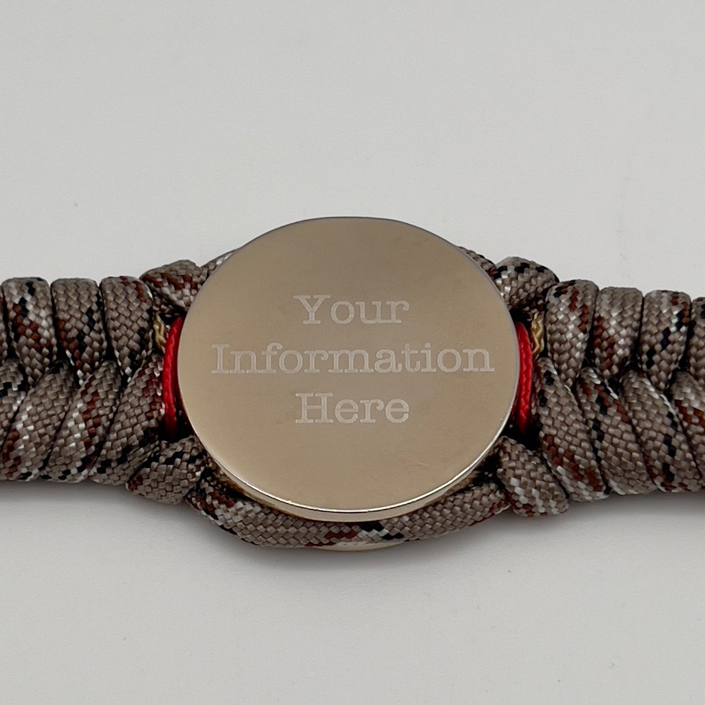 Thick and comfortable braided United States Marine Corps bracelet featuring a 24K gold and silver plated USMC officer Eagle Globe and Anchor medallion, a Cobra style tactical buckle and woven with Desert Camo 550 paracord and Imperial red and gold micro cord.