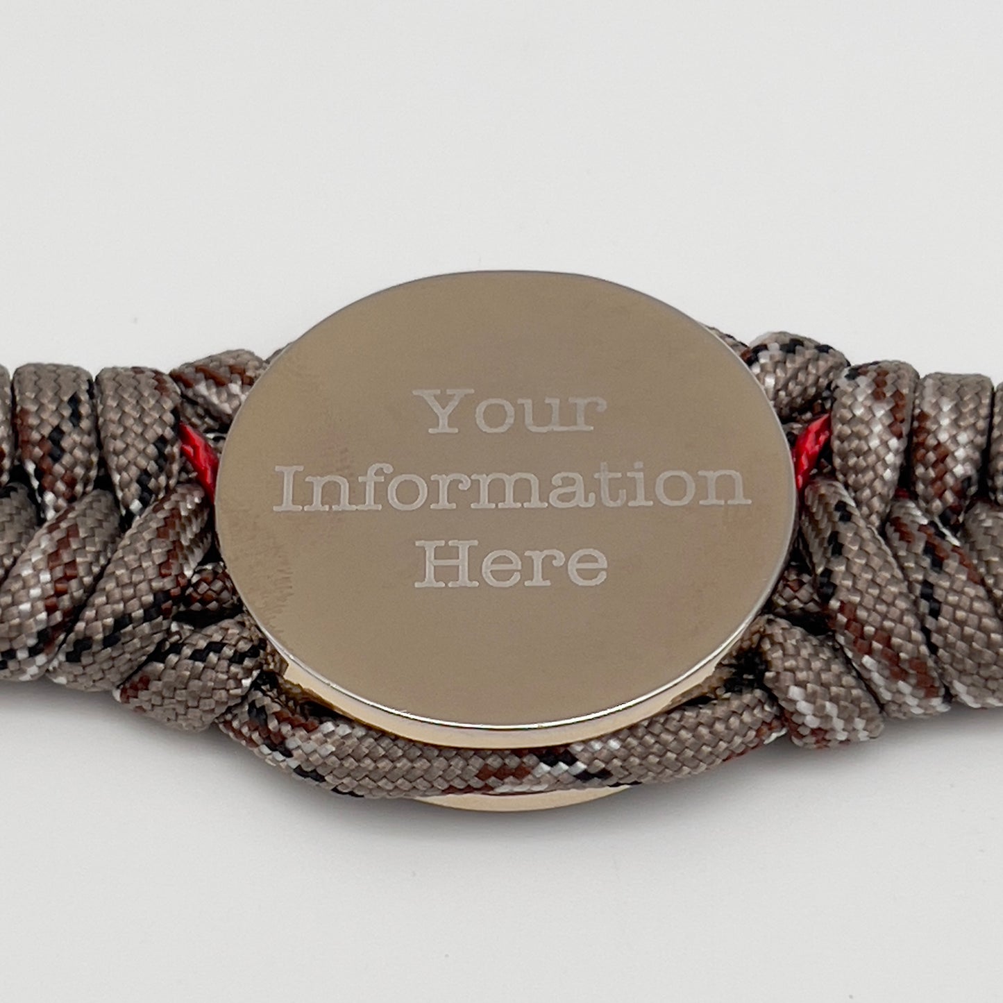 Thick and comfortable braided United States Marine Corps bracelet featuring a 24K gold and silver plated USMC officer Eagle Globe and Anchor medallion, a Cobra style tactical buckle and woven with Desert Camo 550 paracord and Imperial red micro cord.