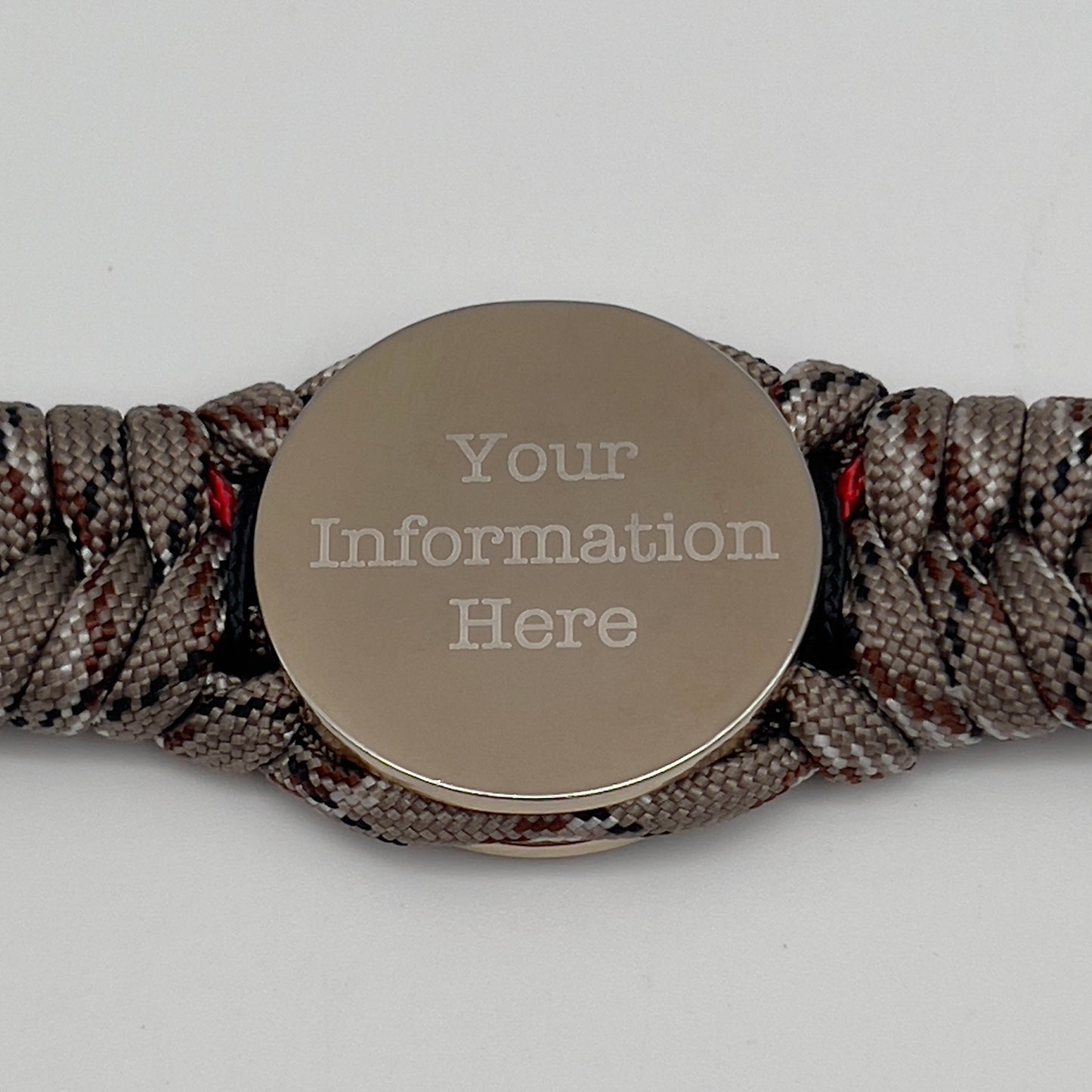 Thick and comfortable braided United States Marine Corps bracelet featuring a 24K gold and silver plated USMC officer Eagle Globe and Anchor medallion, a Cobra style tactical buckle and woven with Desert Camo 550 paracord and Imperial red and black micro cord.