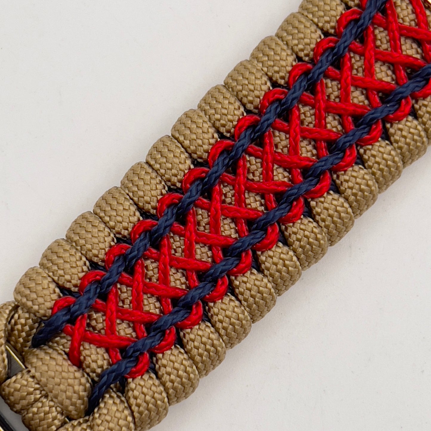 Thick and comfortable braided United States Marine Corps bracelet featuring a 24K gold and silver plated USMC officer Eagle Globe and Anchor medallion, a gold Cobra style tactical buckle and woven with gold 550 paracord and Imperial Red and Navy Blue micro cord.