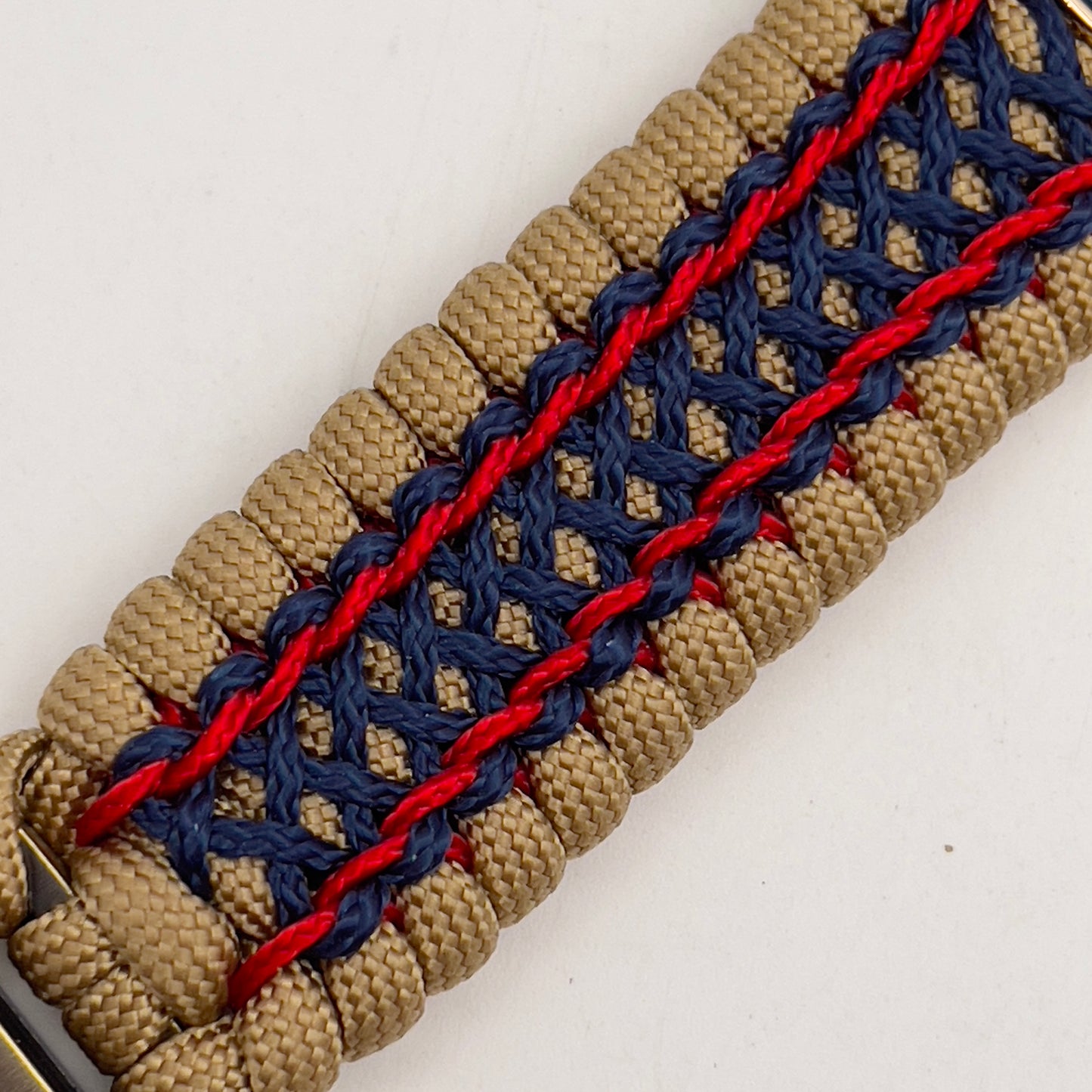 Thick and comfortable braided United States Marine Corps bracelet featuring a 24K gold and silver plated USMC officer Eagle Globe and Anchor medallion, a gold Cobra style tactical buckle and woven with gold 550 paracord and Imperial Red and Navy Blue micro cord.