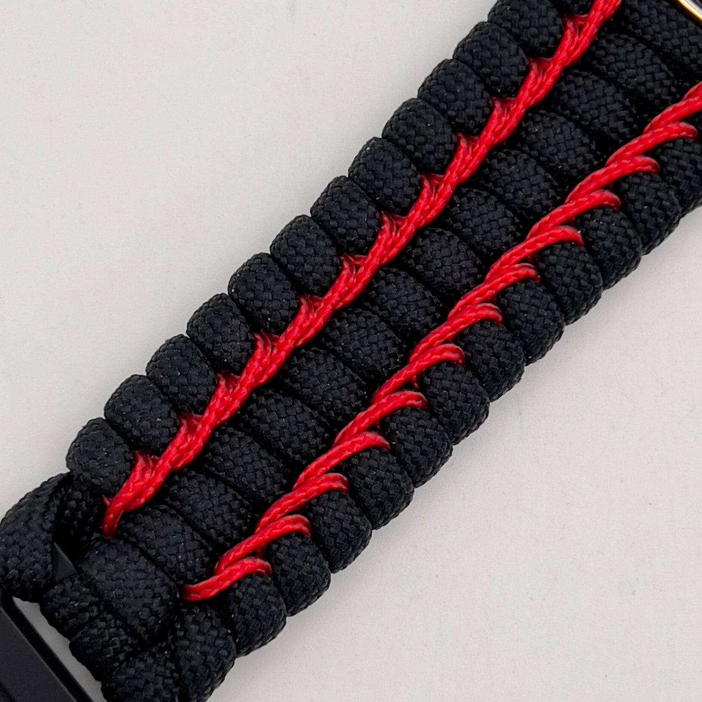 Thick and comfortable braided United States Marine Corps bracelet featuring a 24K gold and silver plated USMC officer Eagle Globe and Anchor medallion, a black Cobra style tactical buckle and woven with black 550 paracord and Imperial Red micro cord.