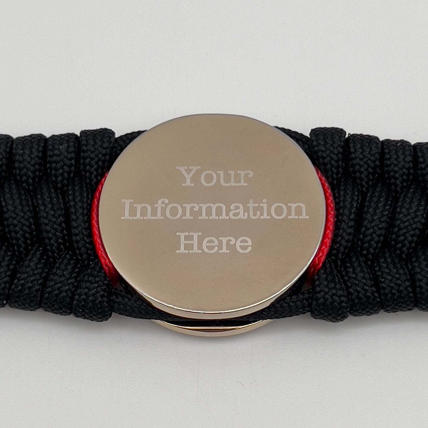 Thick and comfortable braided United States Marine Corps bracelet featuring a 24K gold and silver plated USMC officer Eagle Globe and Anchor medallion, a black Cobra style tactical buckle and woven with black 550 paracord and Imperial Red micro cord.