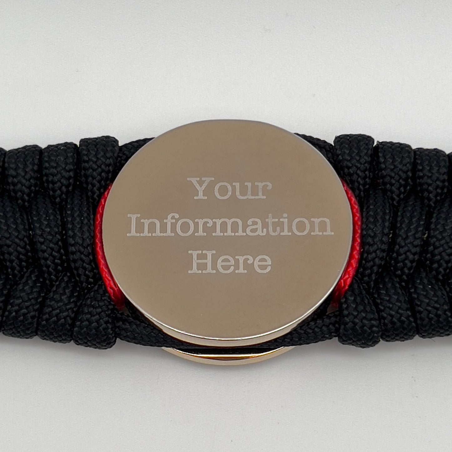 Thick and comfortable braided United States Marine Corps bracelet featuring a 24K gold and silver plated USMC officer Eagle Globe and Anchor medallion, a black Cobra style tactical buckle and woven with black 550 paracord and Imperial Red and gold micro cord.