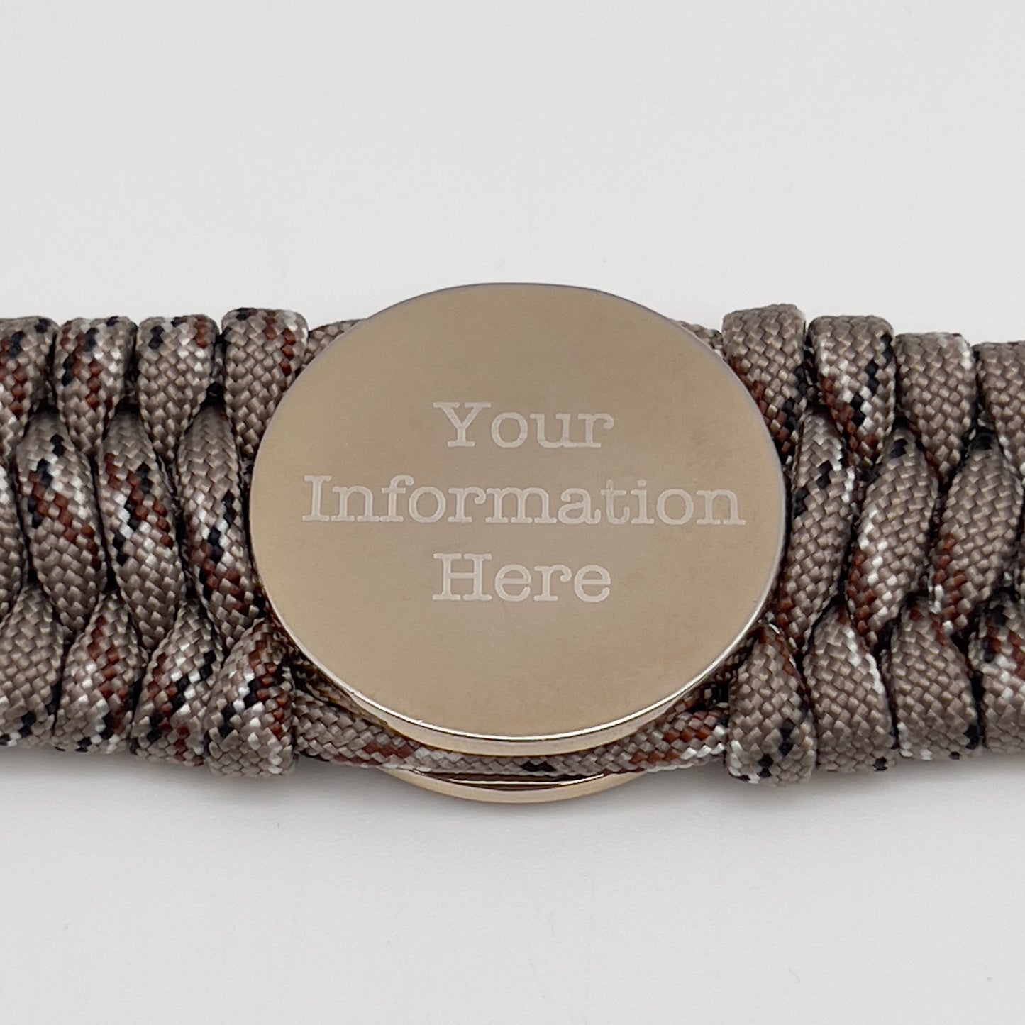 Thick and comfortable braided United States Marine Corps bracelet featuring a 24K gold and silver plated USMC officer Eagle Globe and Anchor medallion, a gold Cobra style tactical buckle and woven with Desert Camo 550 paracord.