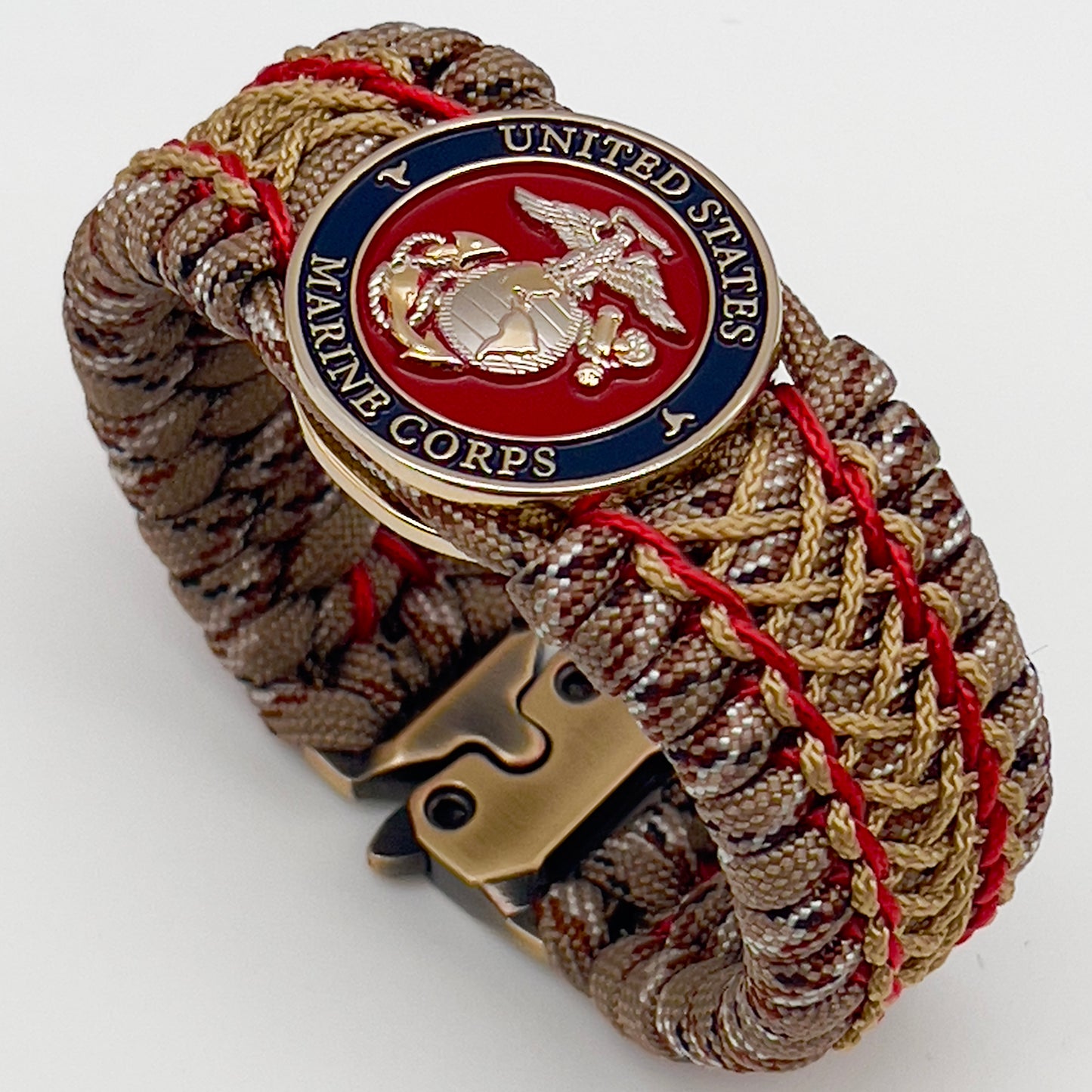 Thick and comfortable braided United States Marine Corps bracelet featuring a 24K gold and silver plated USMC officer Eagle Globe and Anchor medallion, a gold Cobra style tactical buckle and woven with Desert Camo 550 paracord and Imperial Red and Gold micro cord.
