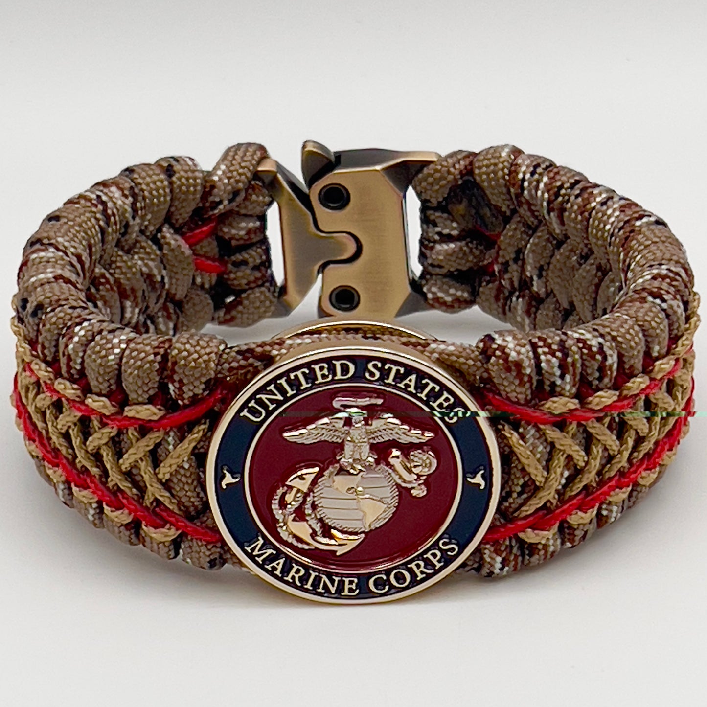 Thick and comfortable braided United States Marine Corps bracelet featuring a 24K gold and silver plated USMC officer Eagle Globe and Anchor medallion, a gold Cobra style tactical buckle and woven with Desert Camo 550 paracord and Imperial Red and Gold micro cord.