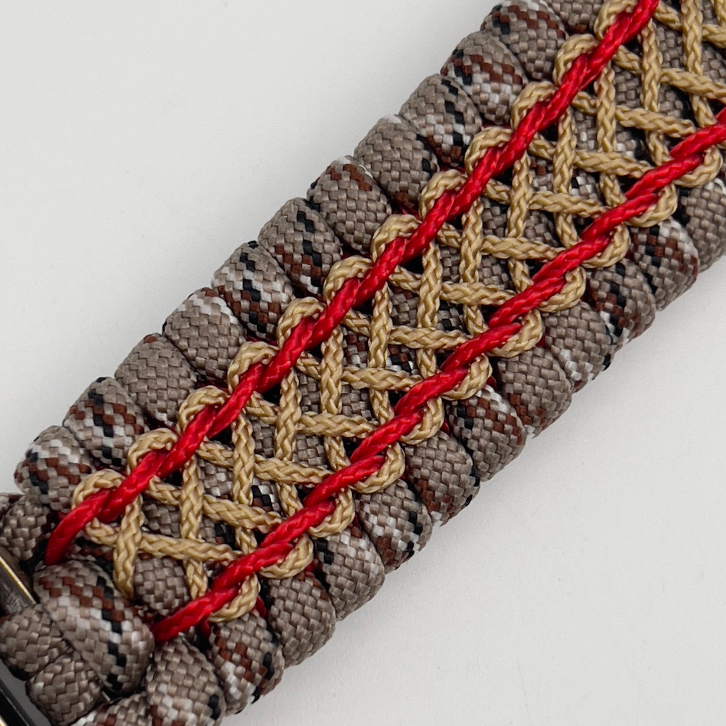 Thick and comfortable braided United States Marine Corps bracelet featuring a 24K gold and silver plated USMC officer Eagle Globe and Anchor medallion, a gold Cobra style tactical buckle and woven with Desert Camo 550 paracord and Imperial Red and Gold micro cord.