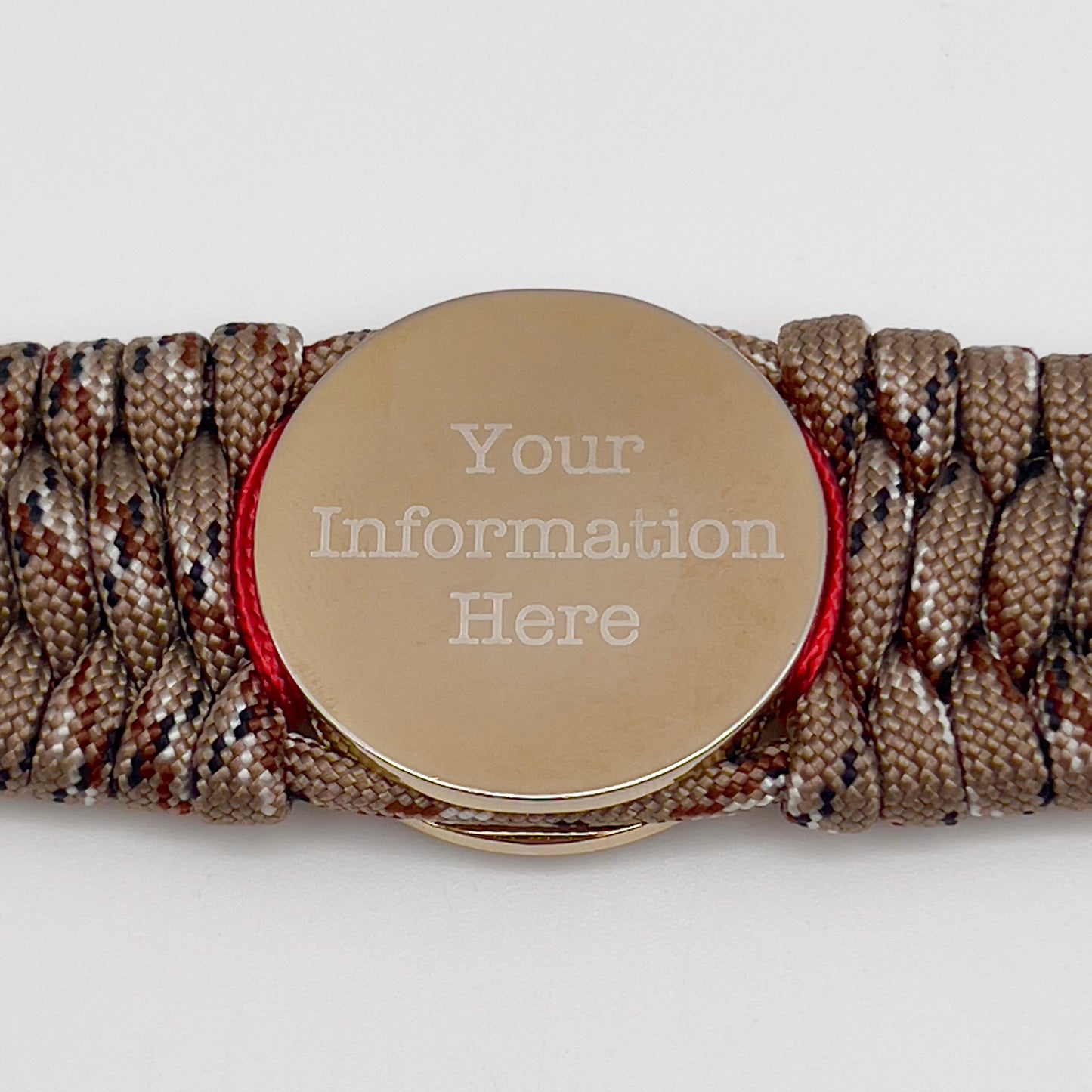 Thick and comfortable braided United States Marine Corps bracelet featuring a 24K gold and silver plated USMC officer Eagle Globe and Anchor medallion, a gold Cobra style tactical buckle and woven with Desert Camo 550 paracord and Imperial Red and Gold micro cord.