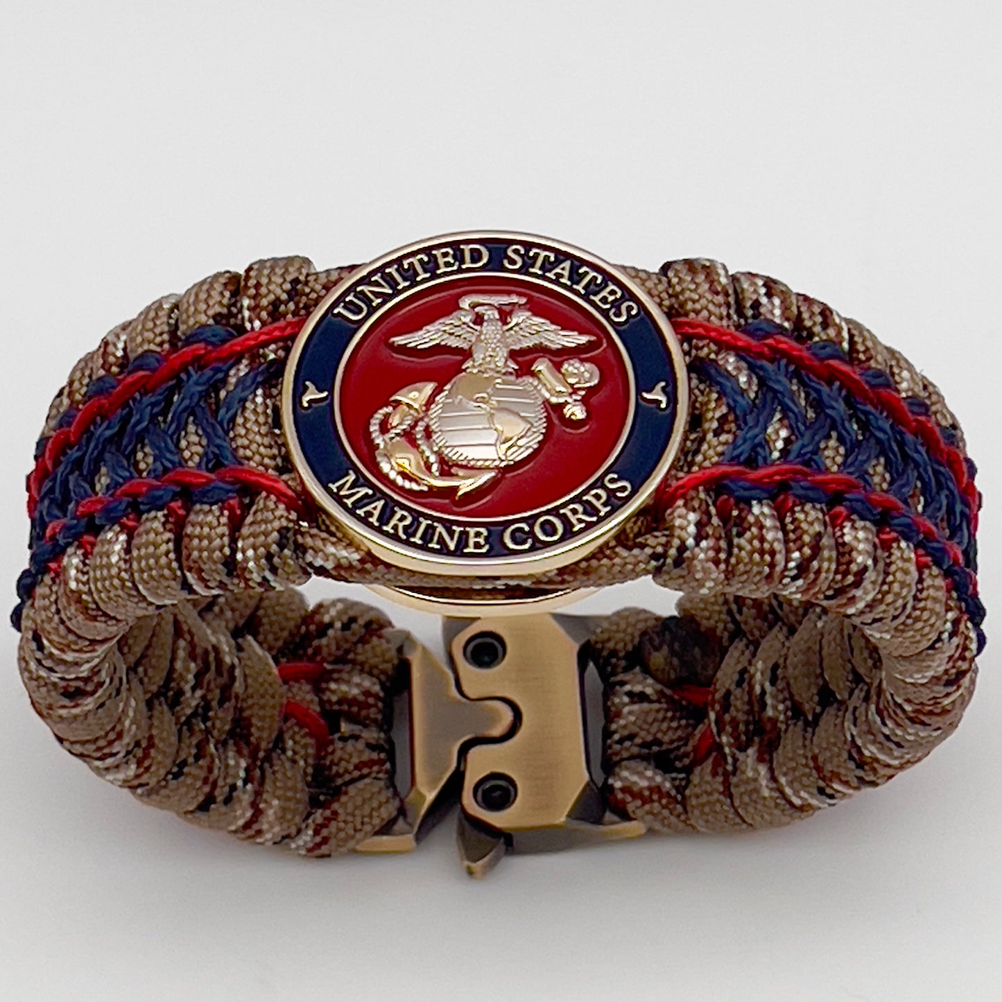 Thick and comfortable braided United States Marine Corps bracelet featuring a 24K gold and silver plated USMC officer Eagle Globe and Anchor medallion, a gold Cobra style tactical buckle and woven with Desert Camo 550 paracord and Imperial Red and Navy Blue micro cord.