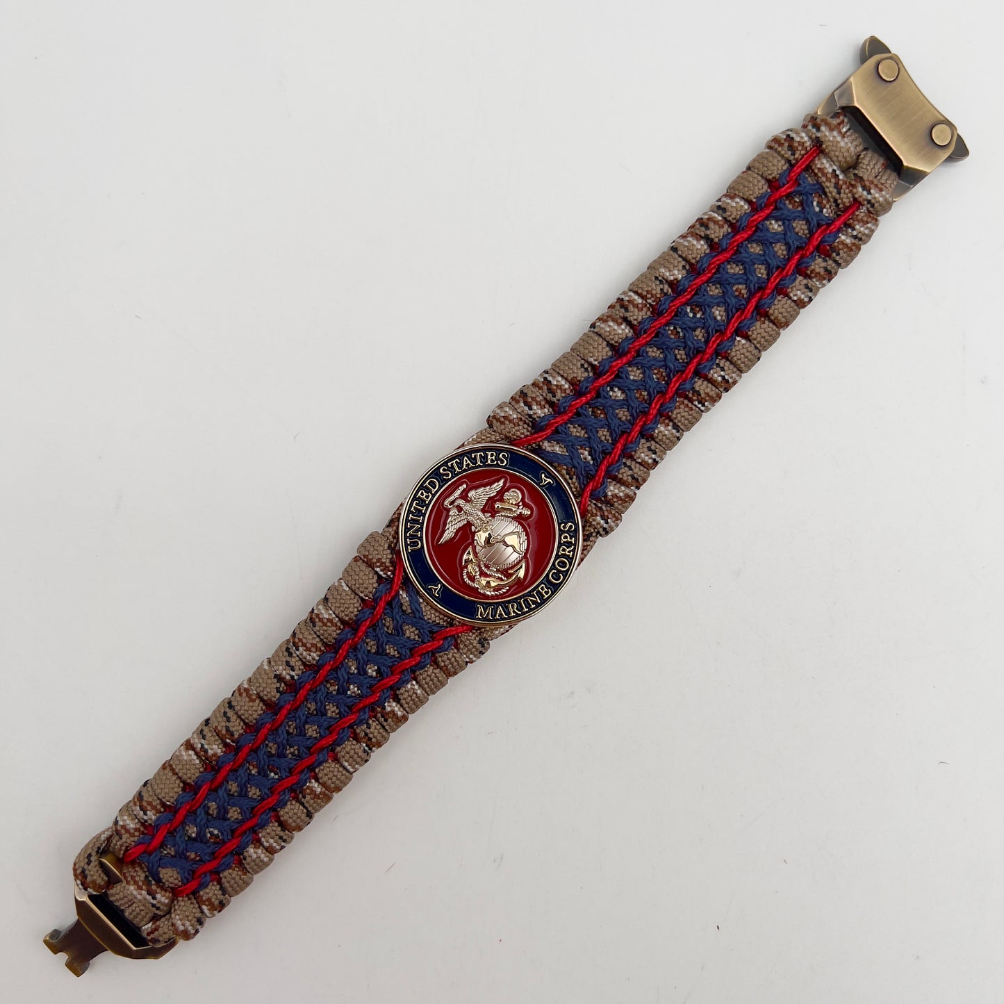 Thick and comfortable braided United States Marine Corps bracelet featuring a 24K gold and silver plated USMC officer Eagle Globe and Anchor medallion, a gold Cobra style tactical buckle and woven with Desert Camo 550 paracord and Imperial Red and Navy Blue micro cord.