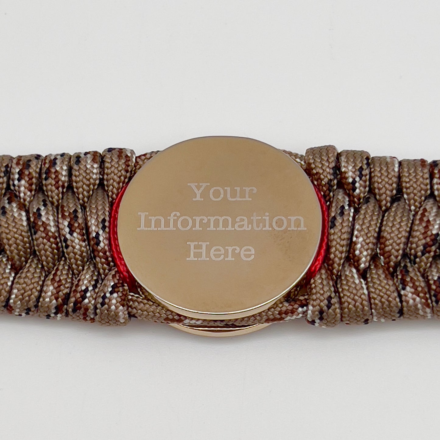Thick and comfortable braided United States Marine Corps bracelet featuring a 24K gold and silver plated USMC officer Eagle Globe and Anchor medallion, a gold Cobra style tactical buckle and woven with Desert Camo 550 paracord and Imperial Red and Navy Blue micro cord.