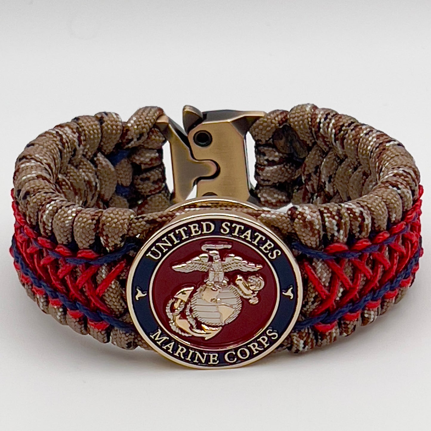 Thick and comfortable braided United States Marine Corps bracelet featuring a 24K gold and silver plated USMC officer Eagle Globe and Anchor medallion, a gold Cobra style tactical buckle and woven with Desert Camo 550 paracord and Imperial Red and Navy Blue micro cord.