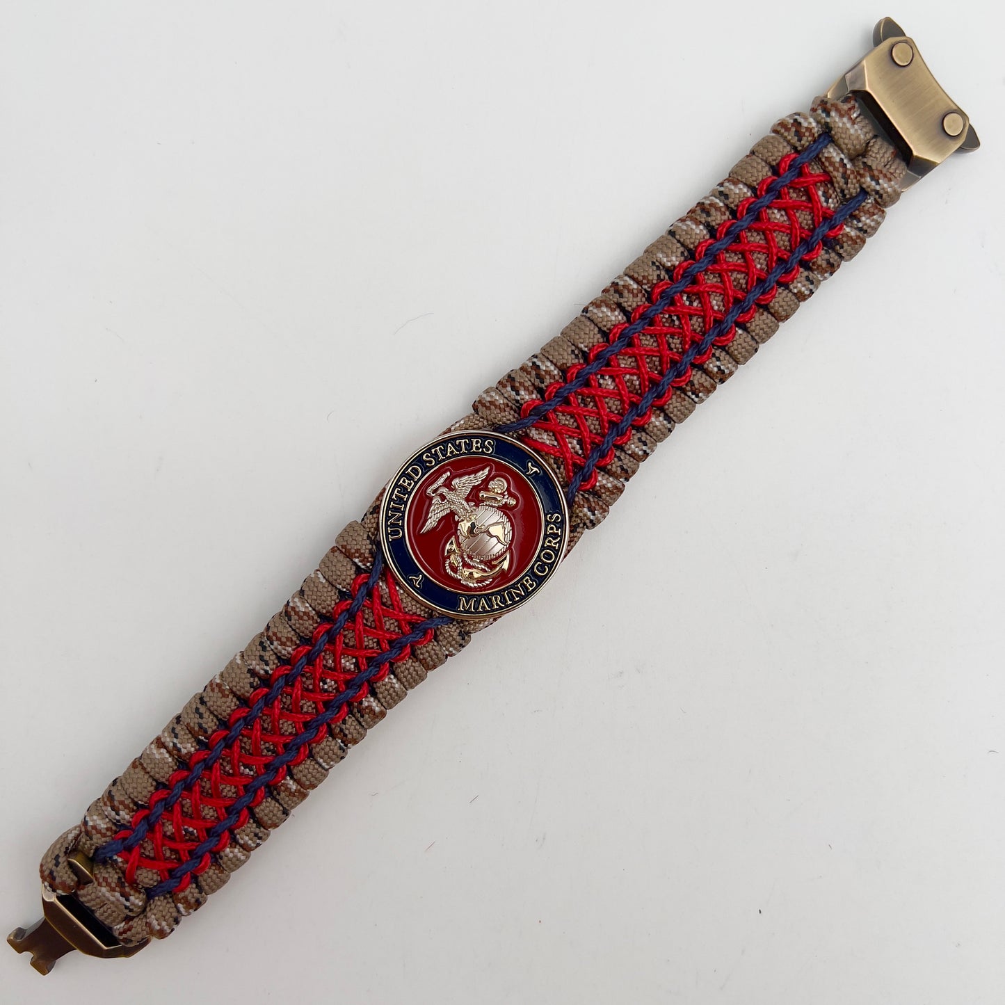 Thick and comfortable braided United States Marine Corps bracelet featuring a 24K gold and silver plated USMC officer Eagle Globe and Anchor medallion, a gold Cobra style tactical buckle and woven with Desert Camo 550 paracord and Imperial Red and Navy Blue micro cord.