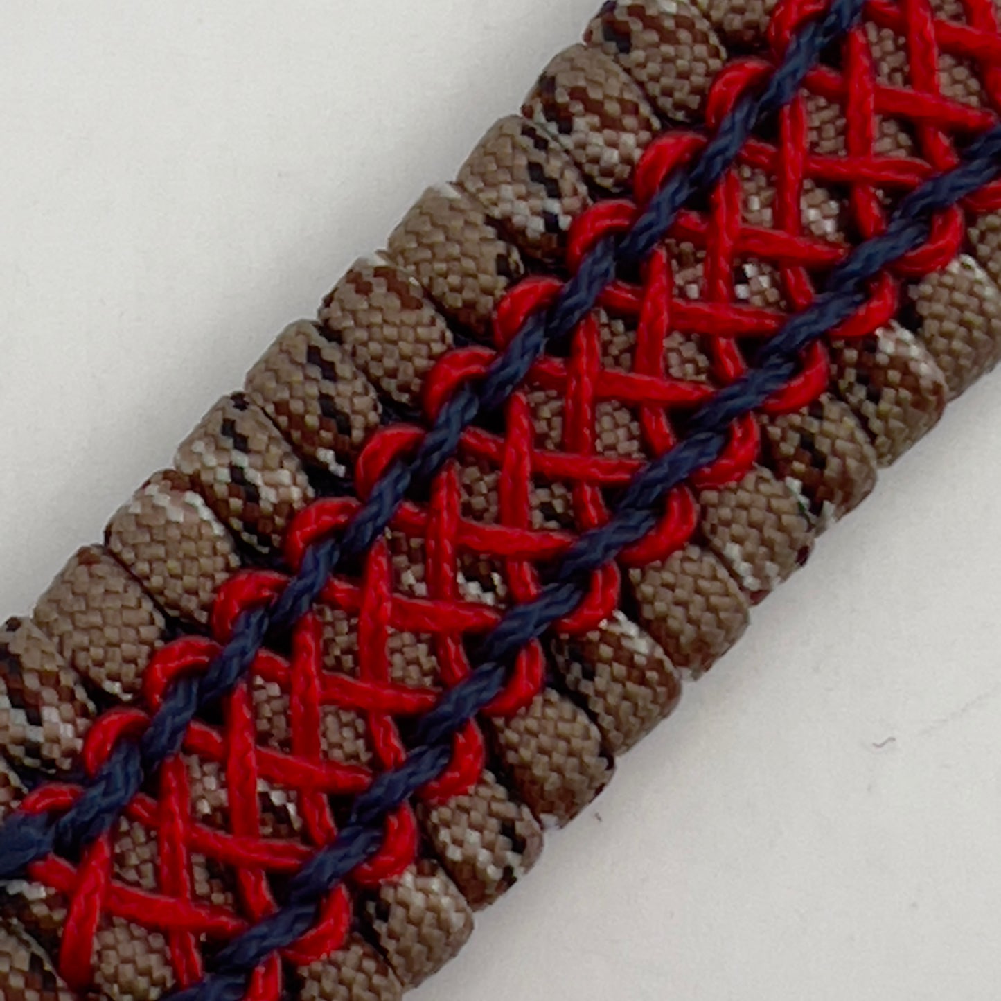Thick and comfortable braided United States Marine Corps bracelet featuring a 24K gold and silver plated USMC officer Eagle Globe and Anchor medallion, a gold Cobra style tactical buckle and woven with Desert Camo 550 paracord and Imperial Red and Navy Blue micro cord.