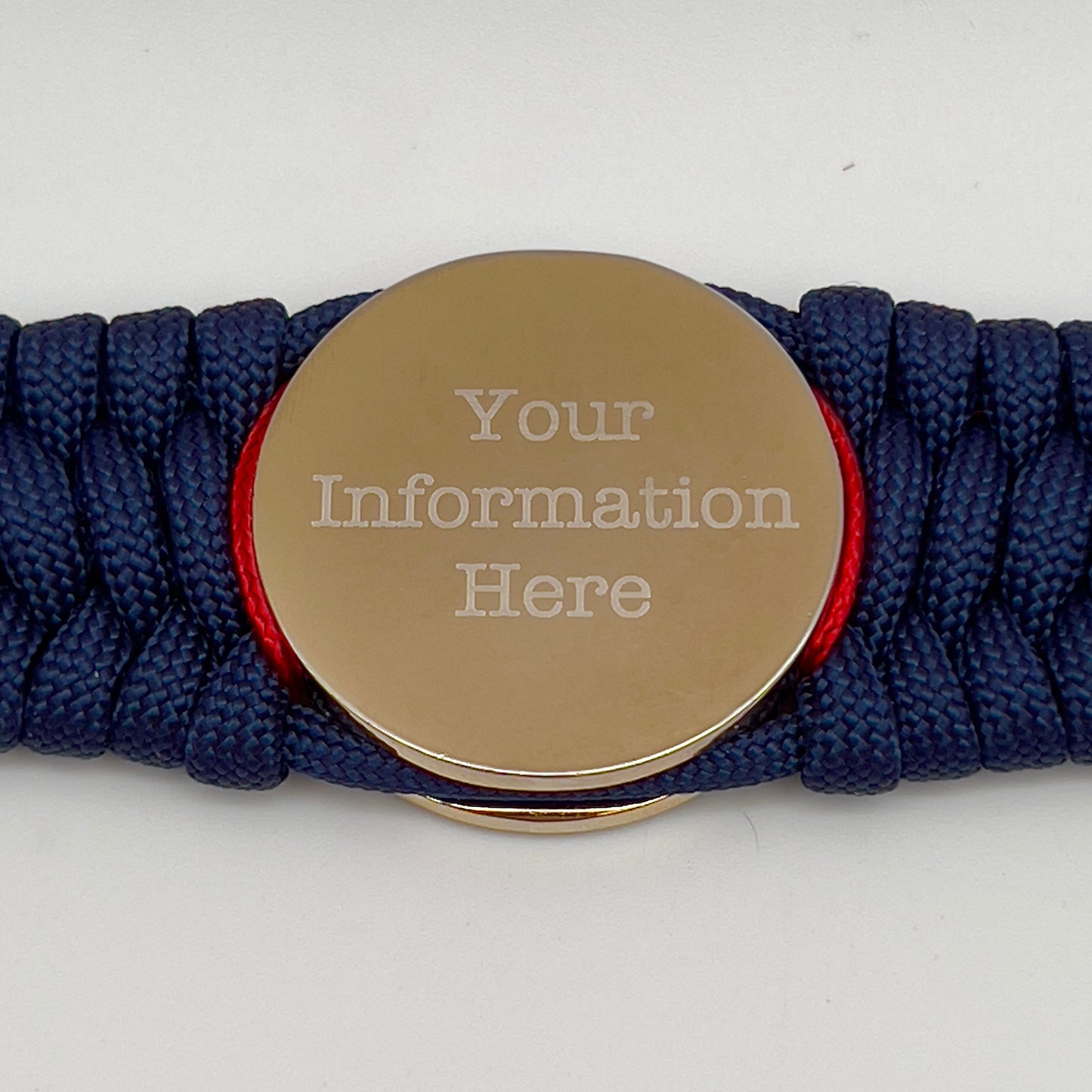 Thick and comfortable braided United States Marine Corps bracelet featuring a 24K gold and silver plated USMC officer Eagle Globe and Anchor medallion, a Cobra style tactical buckle and woven with gold 550 paracord and Imperial Red micro cord.