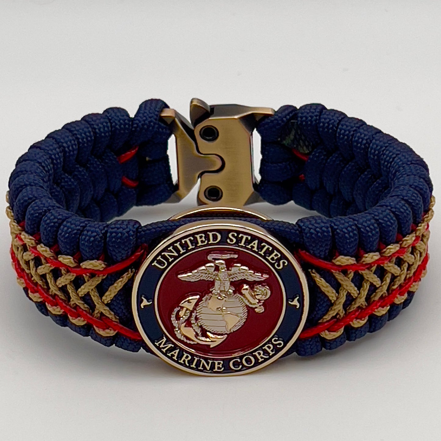 Thick and comfortable braided United States Marine Corps bracelet featuring a 24K gold and silver plated USMC officer Eagle Globe and Anchor medallion, a Cobra style tactical buckle and woven with gold 550 paracord and Imperial Red and Gold micro cord.