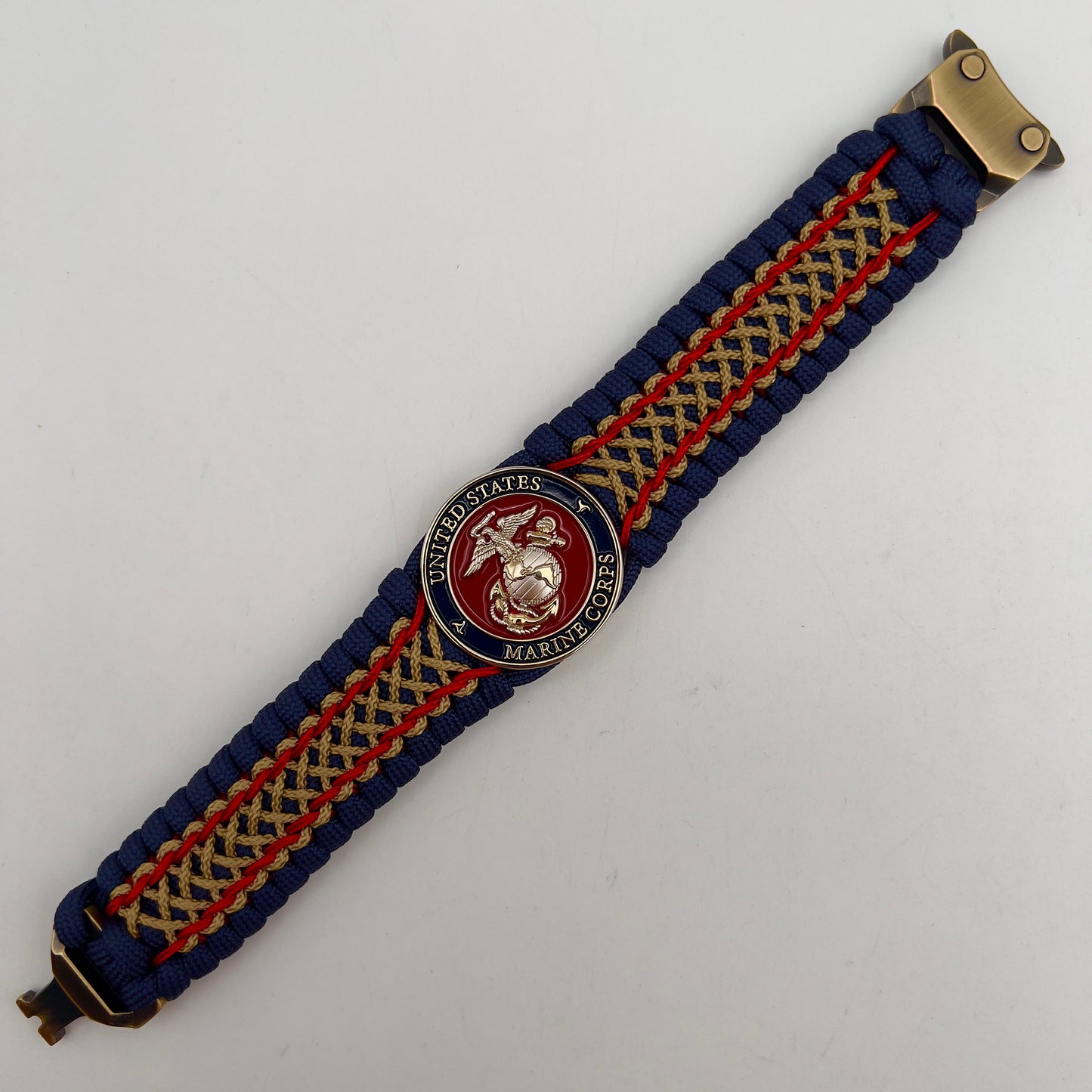 Thick and comfortable braided United States Marine Corps bracelet featuring a 24K gold and silver plated USMC officer Eagle Globe and Anchor medallion, a Cobra style tactical buckle and woven with gold 550 paracord and Imperial Red and Gold micro cord.