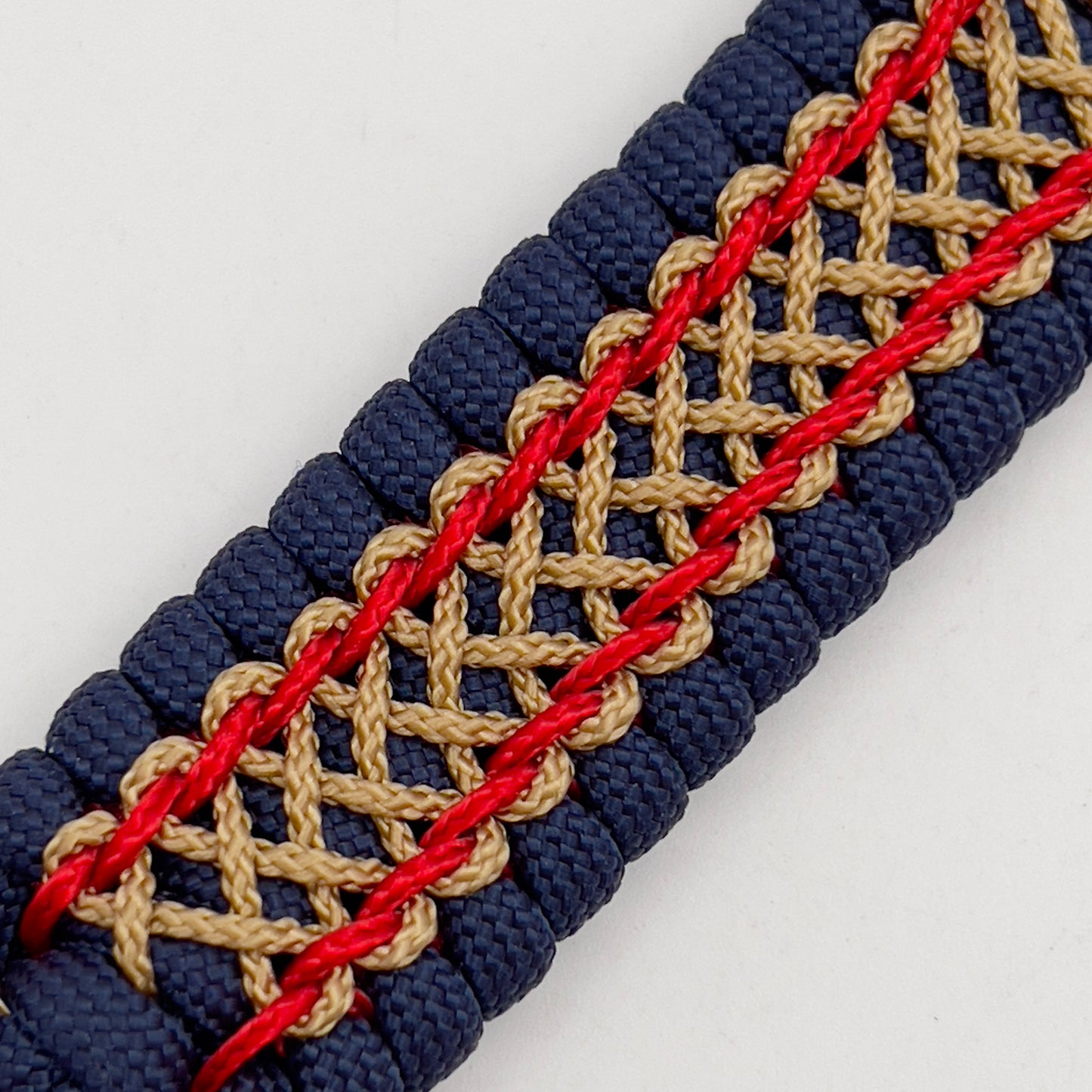 Thick and comfortable braided United States Marine Corps bracelet featuring a 24K gold and silver plated USMC officer Eagle Globe and Anchor medallion, a Cobra style tactical buckle and woven with gold 550 paracord and Imperial Red and Gold micro cord.