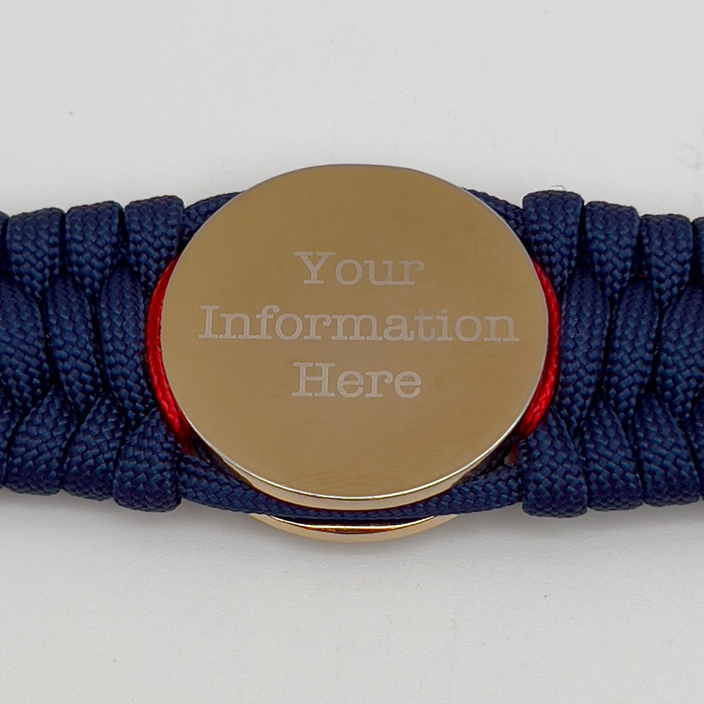 Thick and comfortable braided United States Marine Corps bracelet featuring a 24K gold and silver plated USMC officer Eagle Globe and Anchor medallion, a Cobra style tactical buckle and woven with gold 550 paracord and Imperial Red and Gold micro cord.