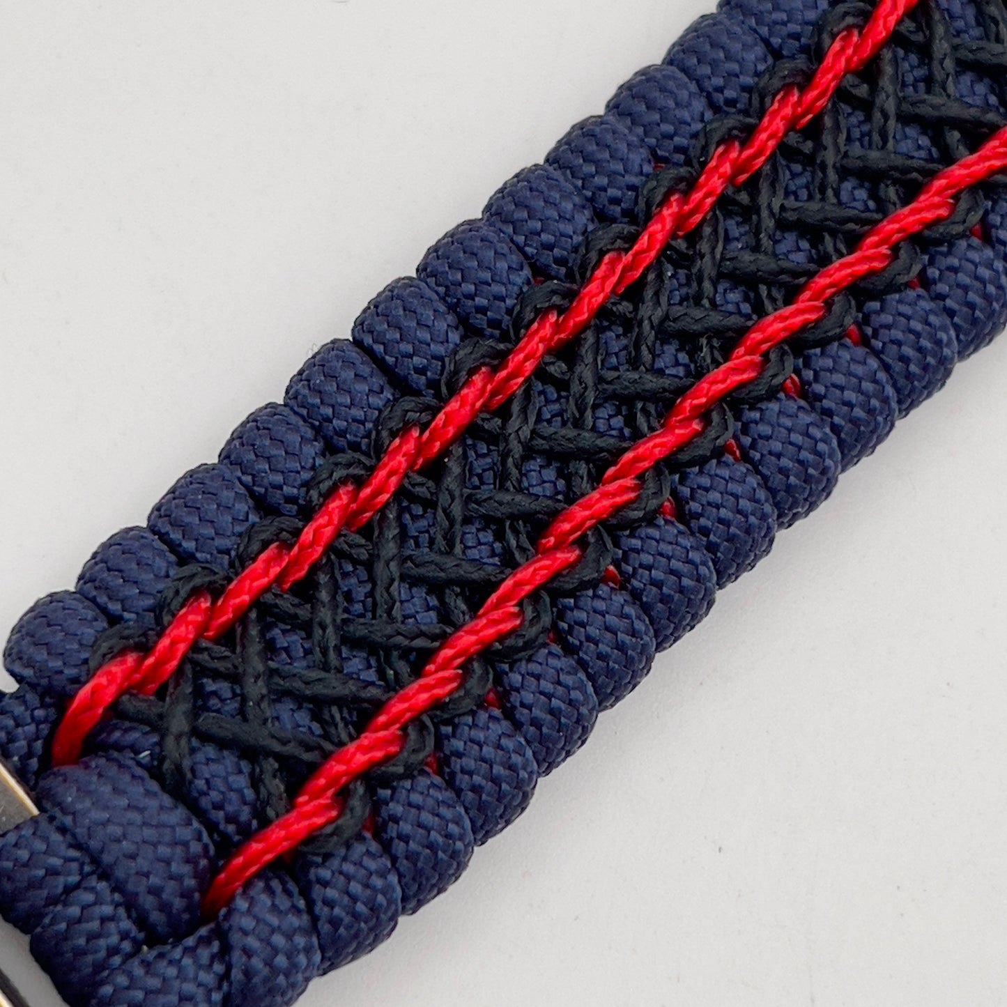 Thick and comfortable braided United States Marine Corps bracelet featuring a 24K gold and silver plated USMC officer Eagle Globe and Anchor medallion, a Cobra style tactical buckle and woven with gold 550 paracord and Imperial Red and Black micro cord.