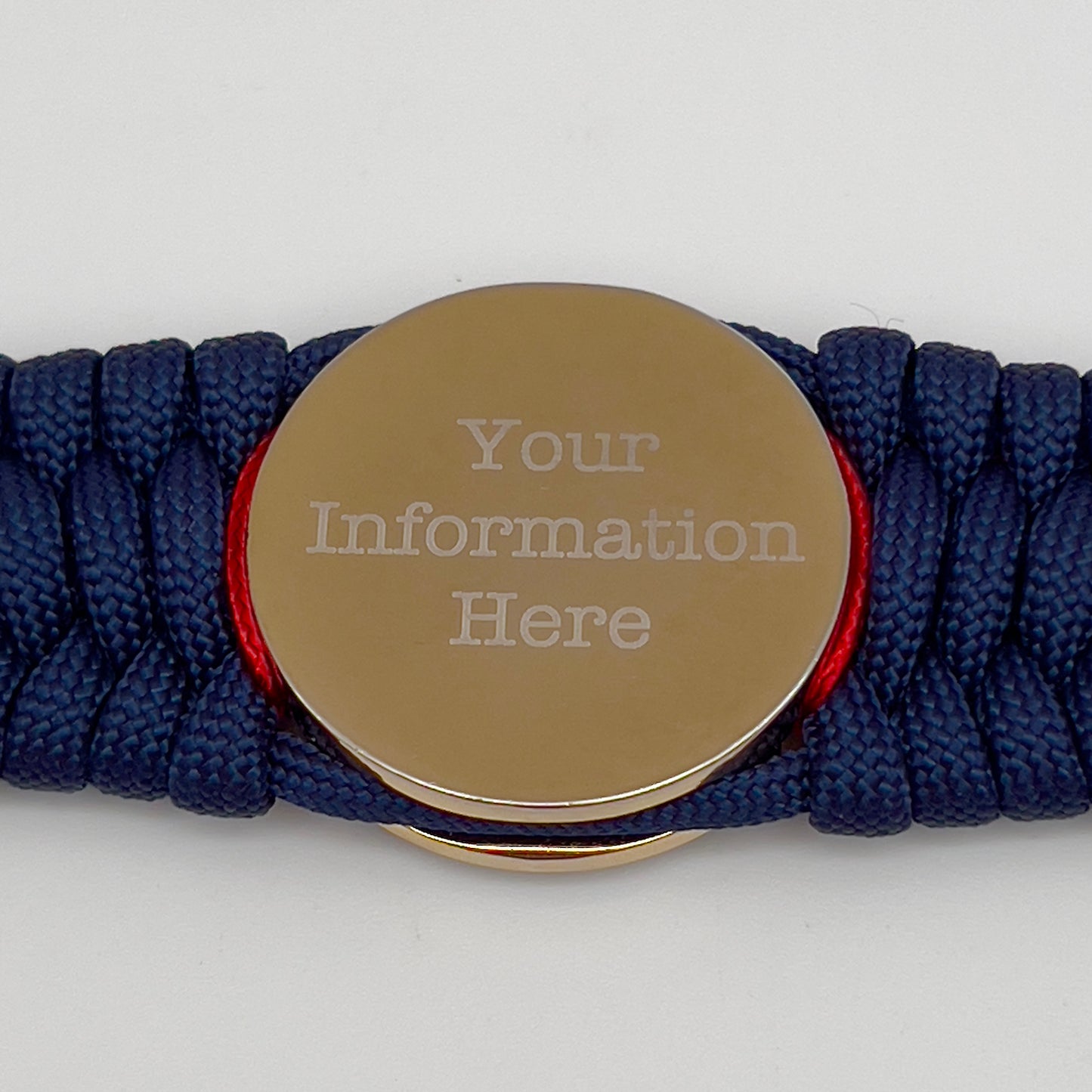 Thick and comfortable braided United States Marine Corps bracelet featuring a 24K gold and silver plated USMC officer Eagle Globe and Anchor medallion, a Cobra style tactical buckle and woven with gold 550 paracord and Imperial Red and Black micro cord.