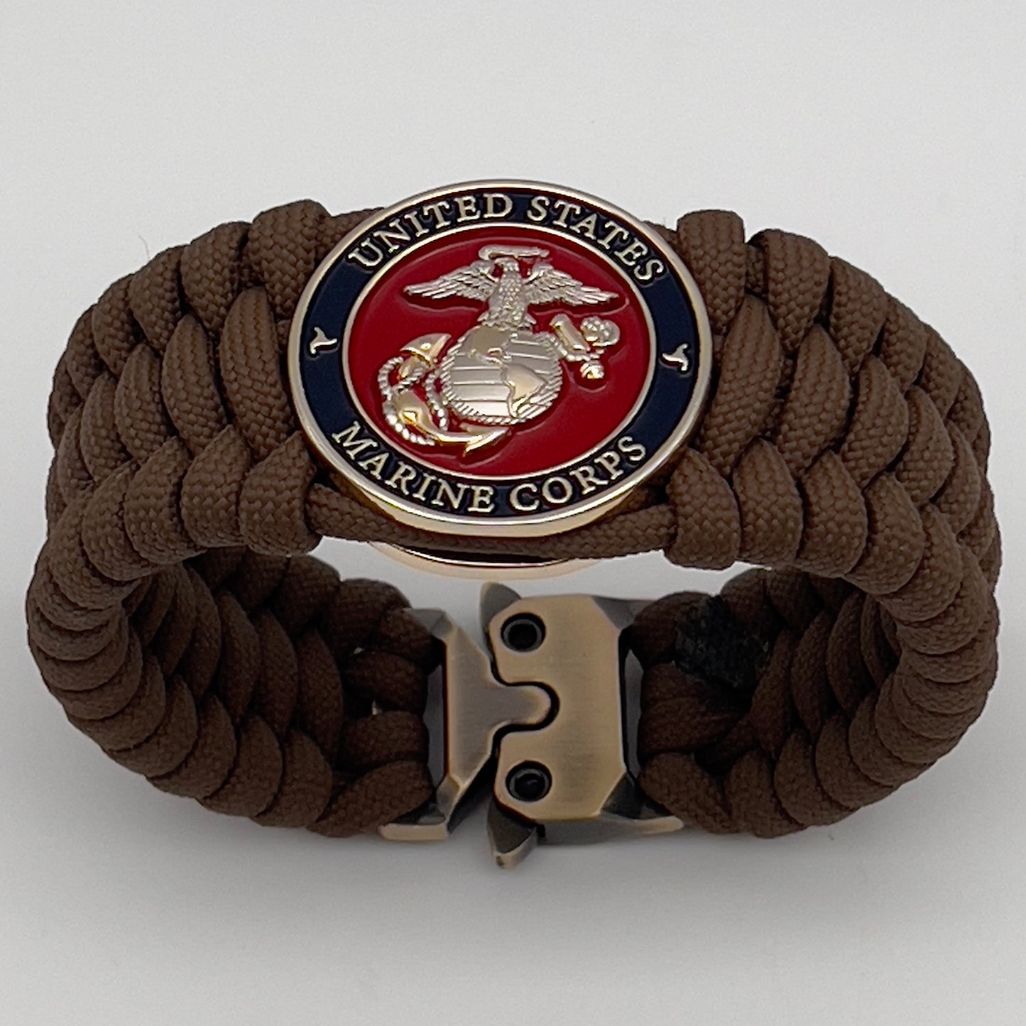 Thick and comfortable braided United States Marine Corps bracelet featuring a 24K gold and silver plated USMC officer Eagle Globe and Anchor medallion, a Cobra style tactical buckle and woven with Coyote Brown 550 paracord.