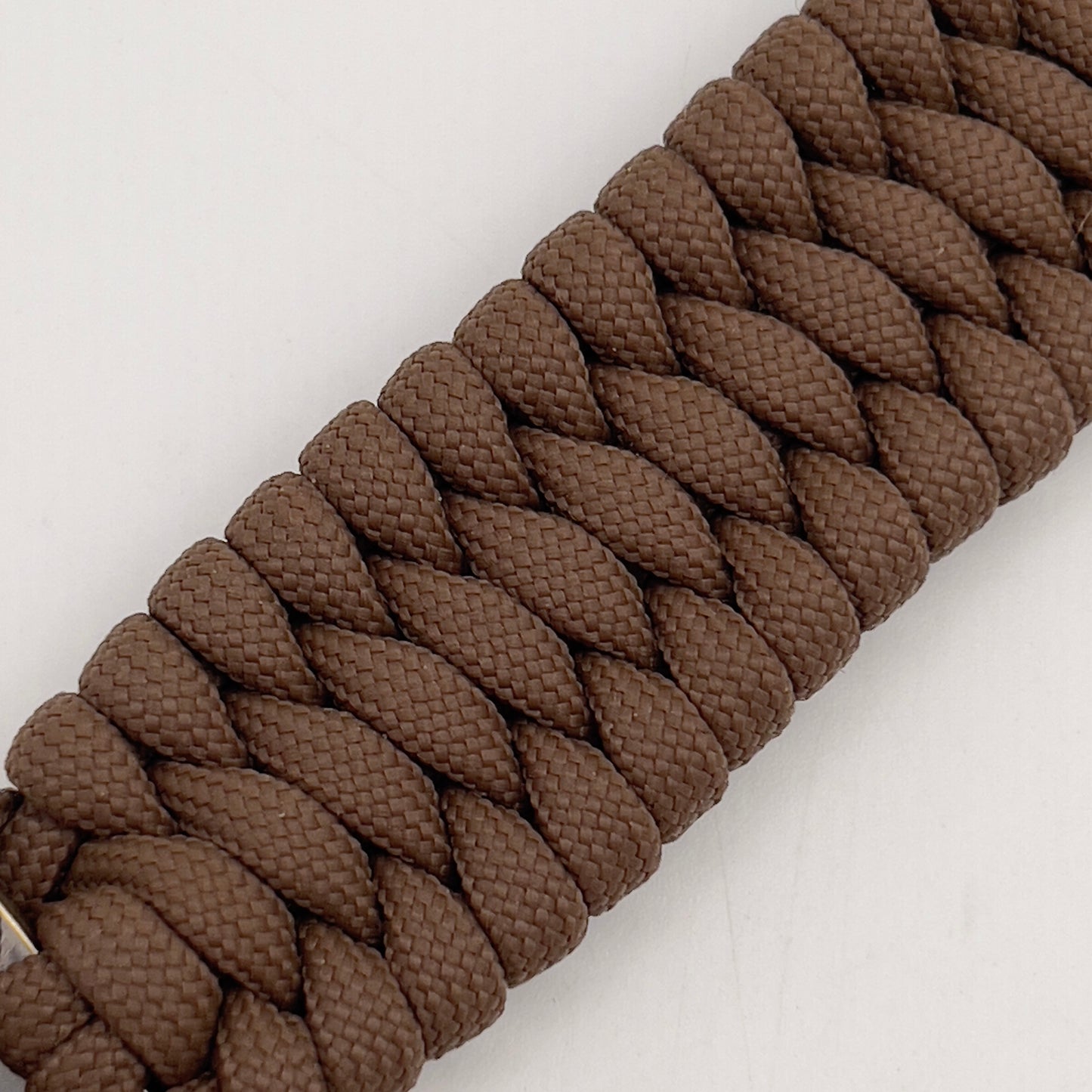 Thick and comfortable braided United States Marine Corps bracelet featuring a 24K gold and silver plated USMC officer Eagle Globe and Anchor medallion, a Cobra style tactical buckle and woven with Coyote Brown 550 paracord.