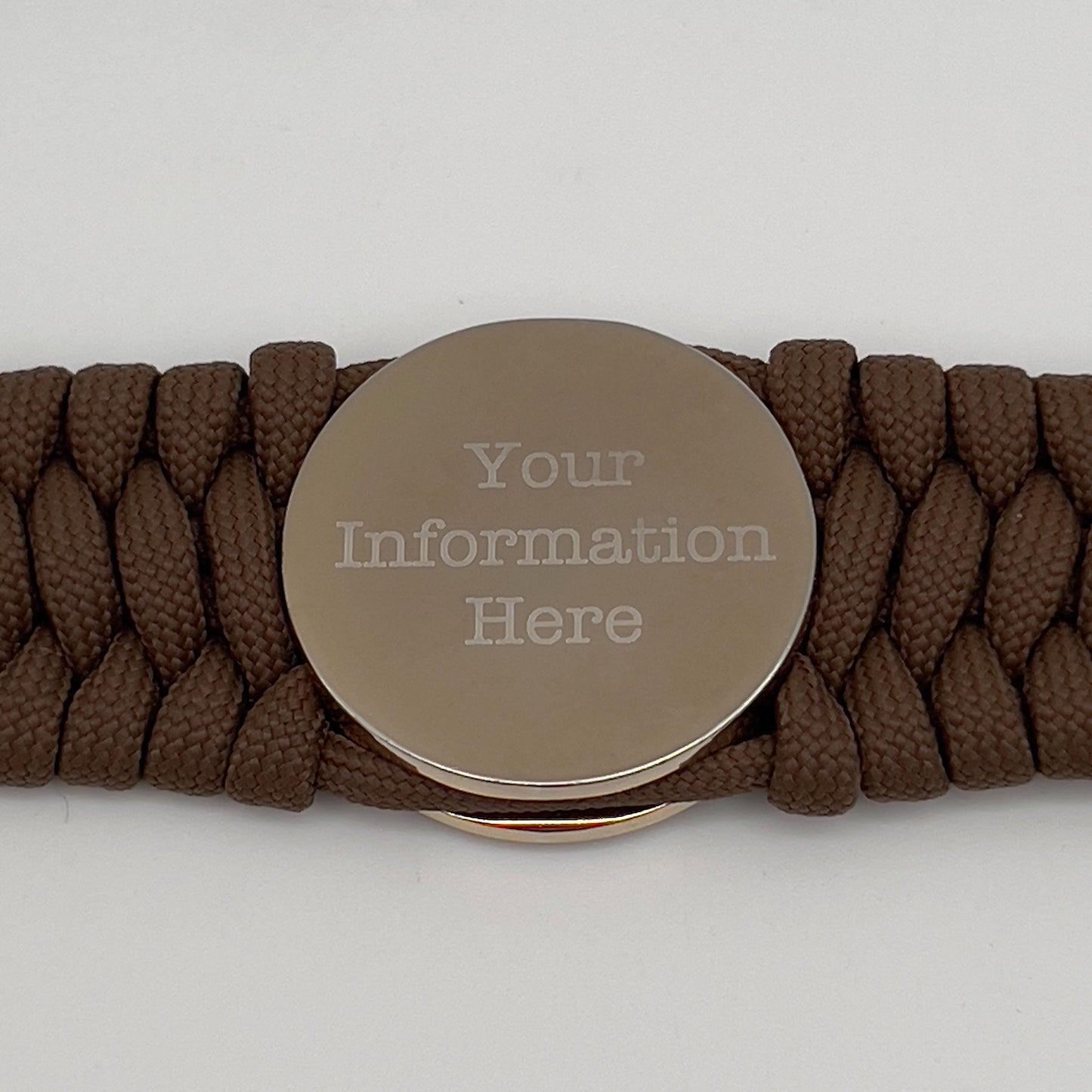 Thick and comfortable braided United States Marine Corps bracelet featuring a 24K gold and silver plated USMC officer Eagle Globe and Anchor medallion, a Cobra style tactical buckle and woven with Coyote Brown 550 paracord.