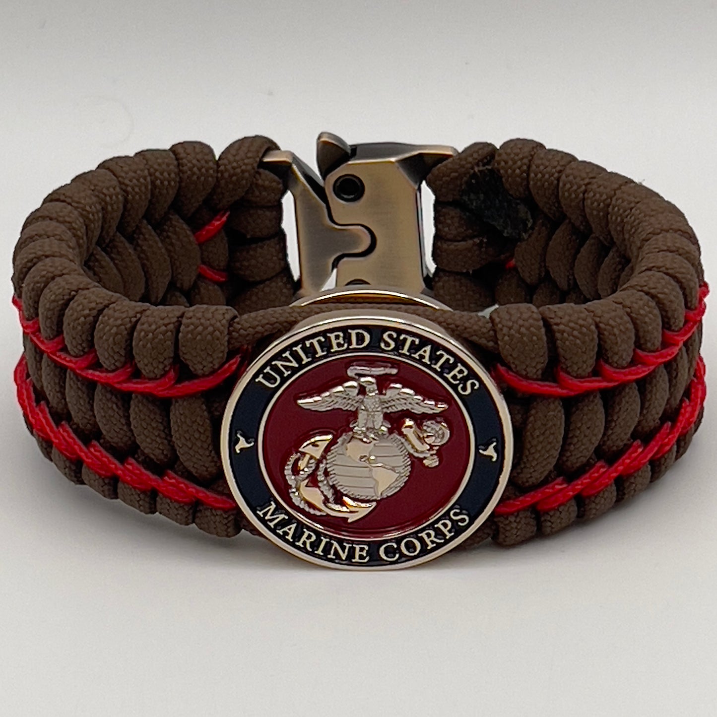 Thick and comfortable braided United States Marine Corps bracelet featuring a 24K gold and silver plated USMC officer Eagle Globe and Anchor medallion, a Cobra style tactical buckle and woven with Coyote Brown 550 paracord and Imperial Red micro cord.