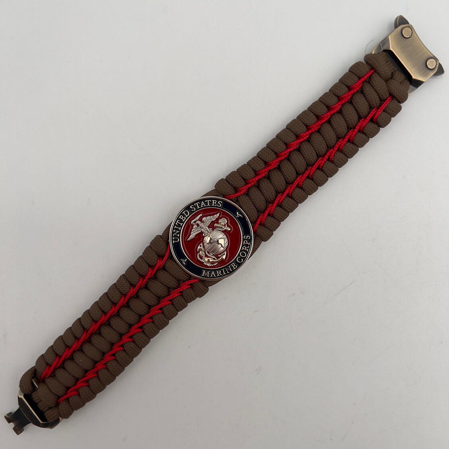 Thick and comfortable braided United States Marine Corps bracelet featuring a 24K gold and silver plated USMC officer Eagle Globe and Anchor medallion, a Cobra style tactical buckle and woven with Coyote Brown 550 paracord and Imperial Red micro cord.