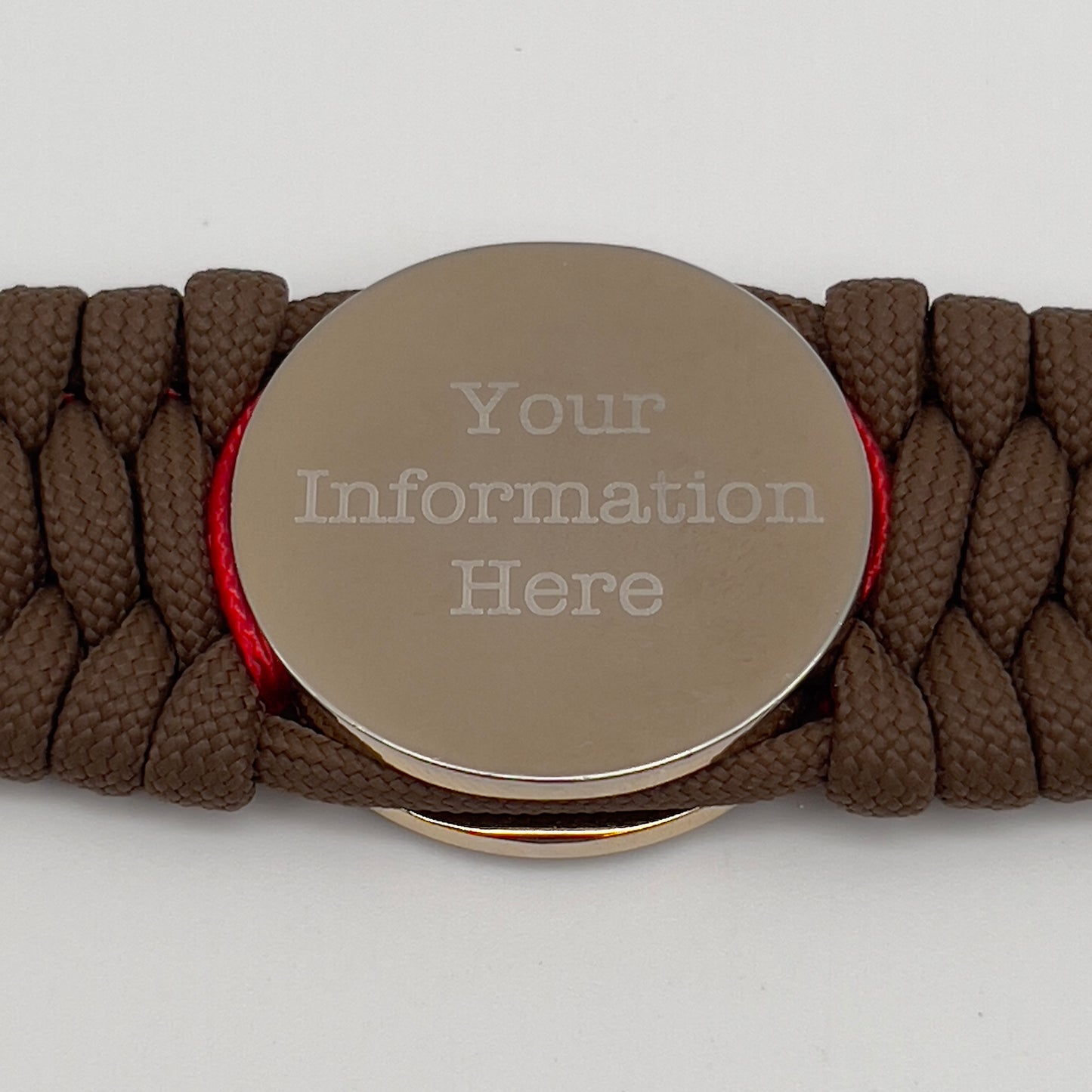 Thick and comfortable braided United States Marine Corps bracelet featuring a 24K gold and silver plated USMC officer Eagle Globe and Anchor medallion, a Cobra style tactical buckle and woven with Coyote Brown 550 paracord and Imperial Red micro cord.
