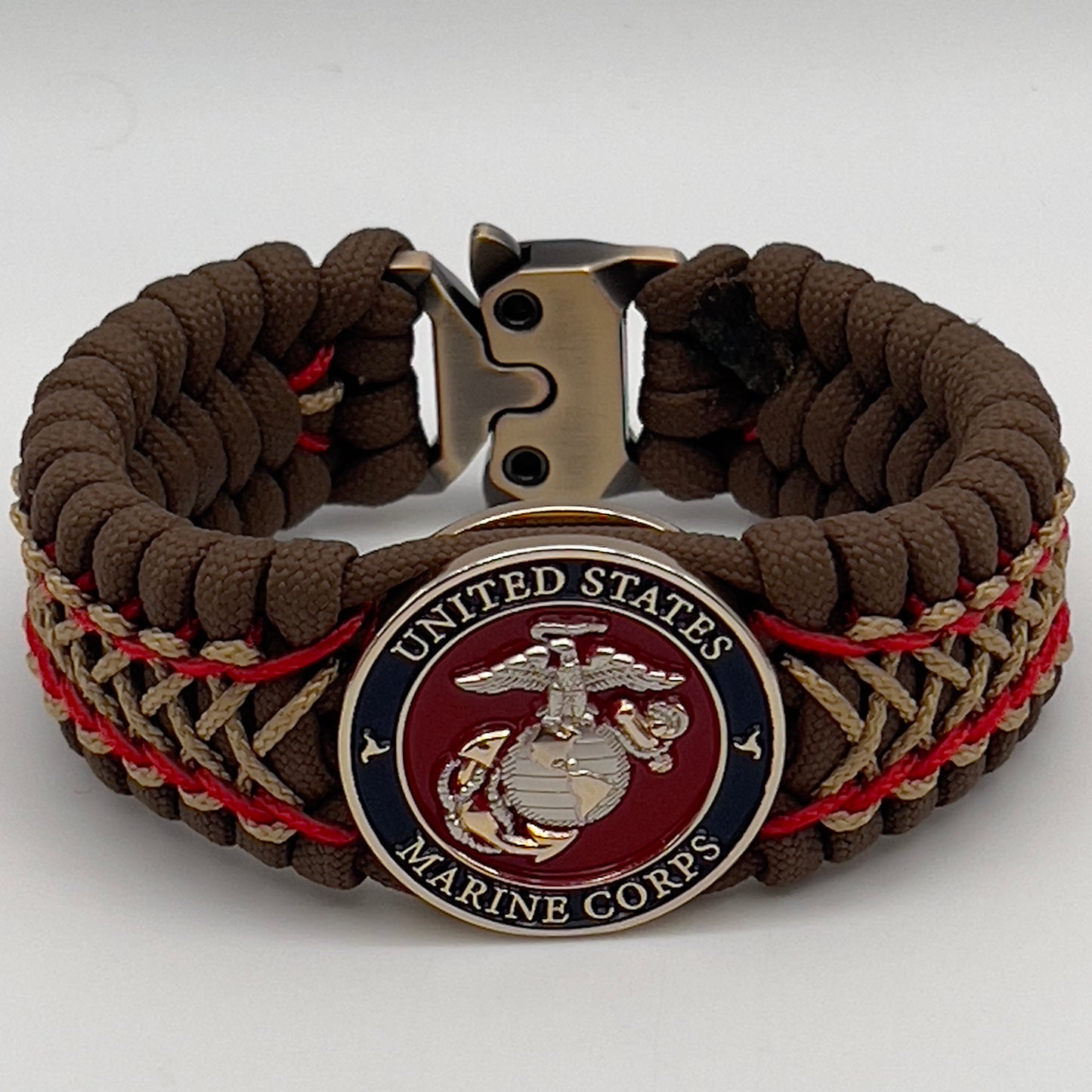 Thick and comfortable braided United States Marine Corps bracelet featuring a 24K gold and silver plated USMC officer Eagle Globe and Anchor medallion, a Cobra style tactical buckle and woven with Coyote Brown 550 paracord and Imperial Red and gold micro cord.