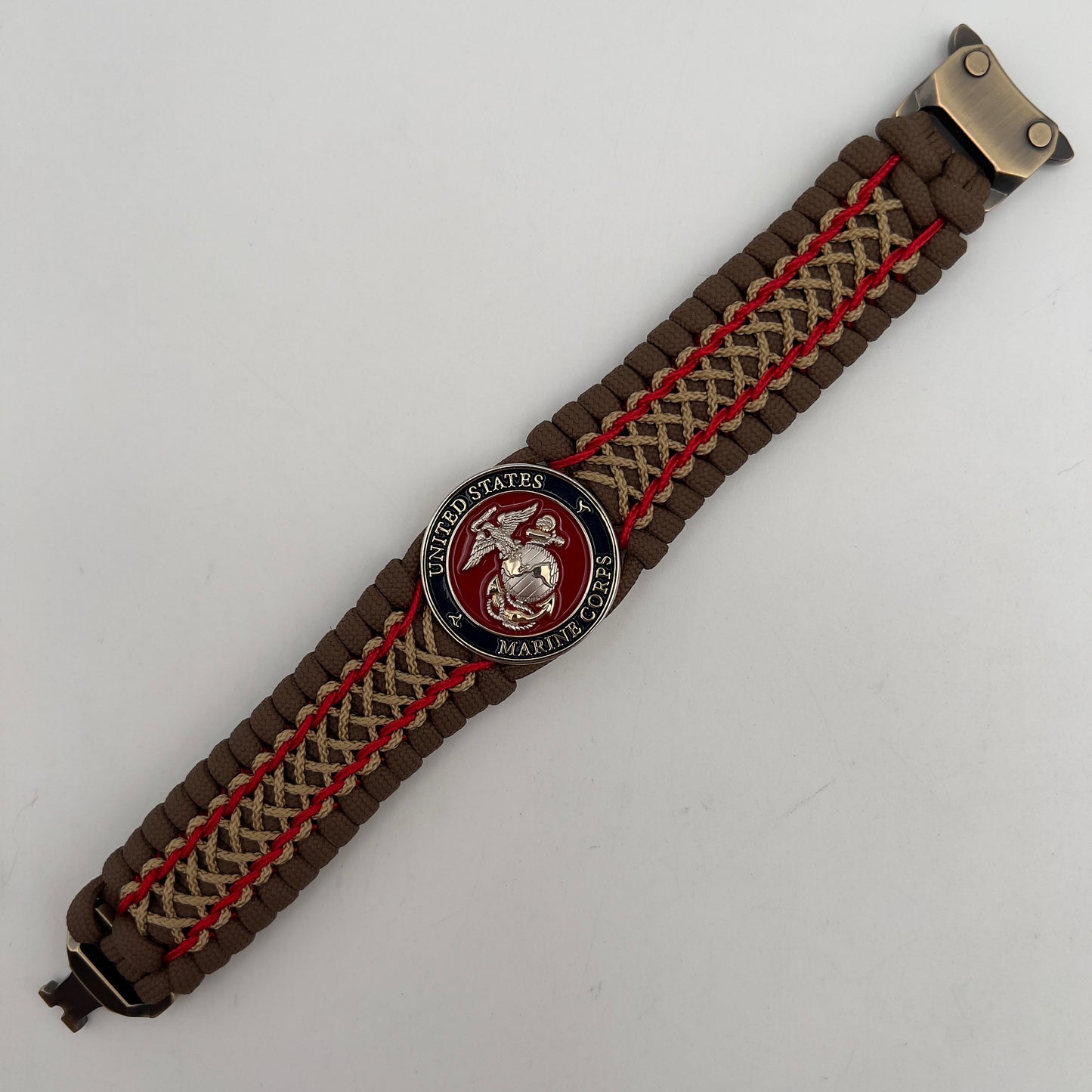 Thick and comfortable braided United States Marine Corps bracelet featuring a 24K gold and silver plated USMC officer Eagle Globe and Anchor medallion, a Cobra style tactical buckle and woven with Coyote Brown 550 paracord and Imperial Red and gold micro cord.