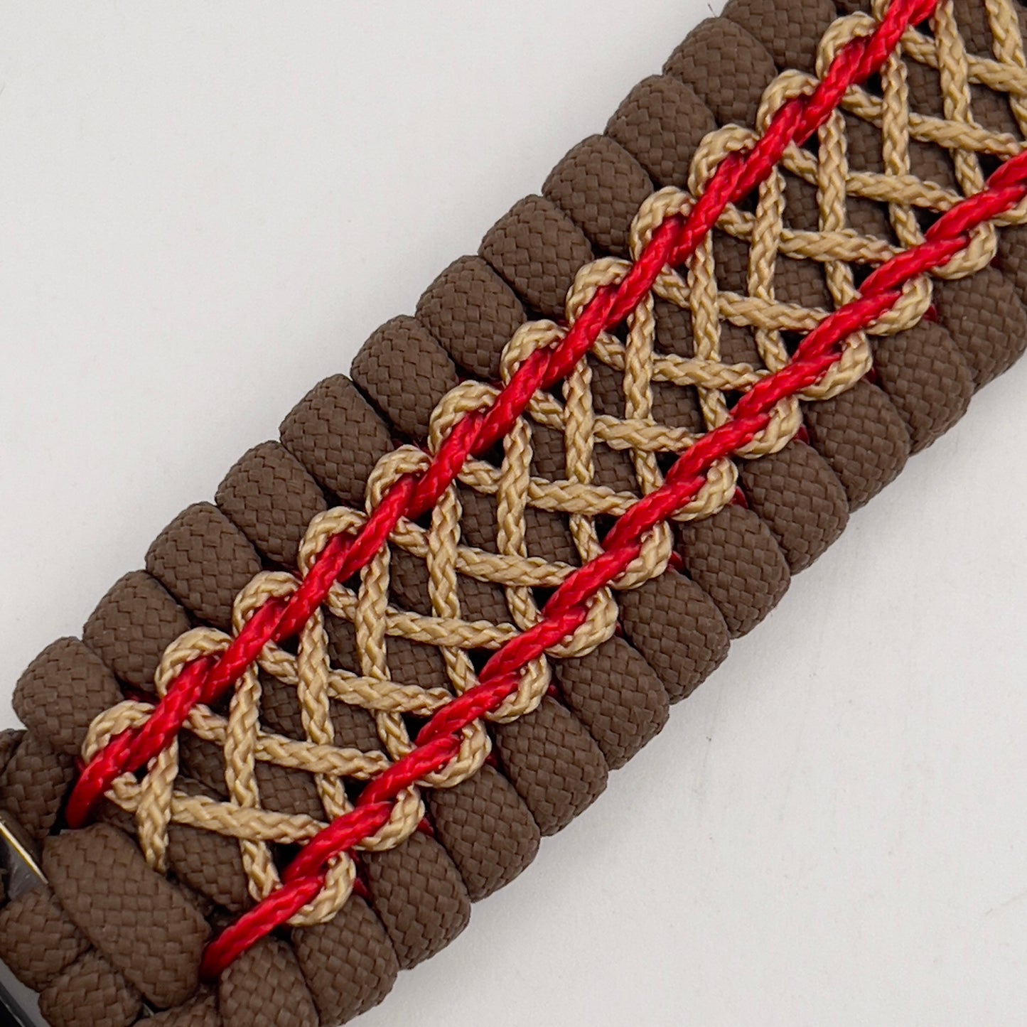 Thick and comfortable braided United States Marine Corps bracelet featuring a 24K gold and silver plated USMC officer Eagle Globe and Anchor medallion, a Cobra style tactical buckle and woven with Coyote Brown 550 paracord and Imperial Red and gold micro cord.