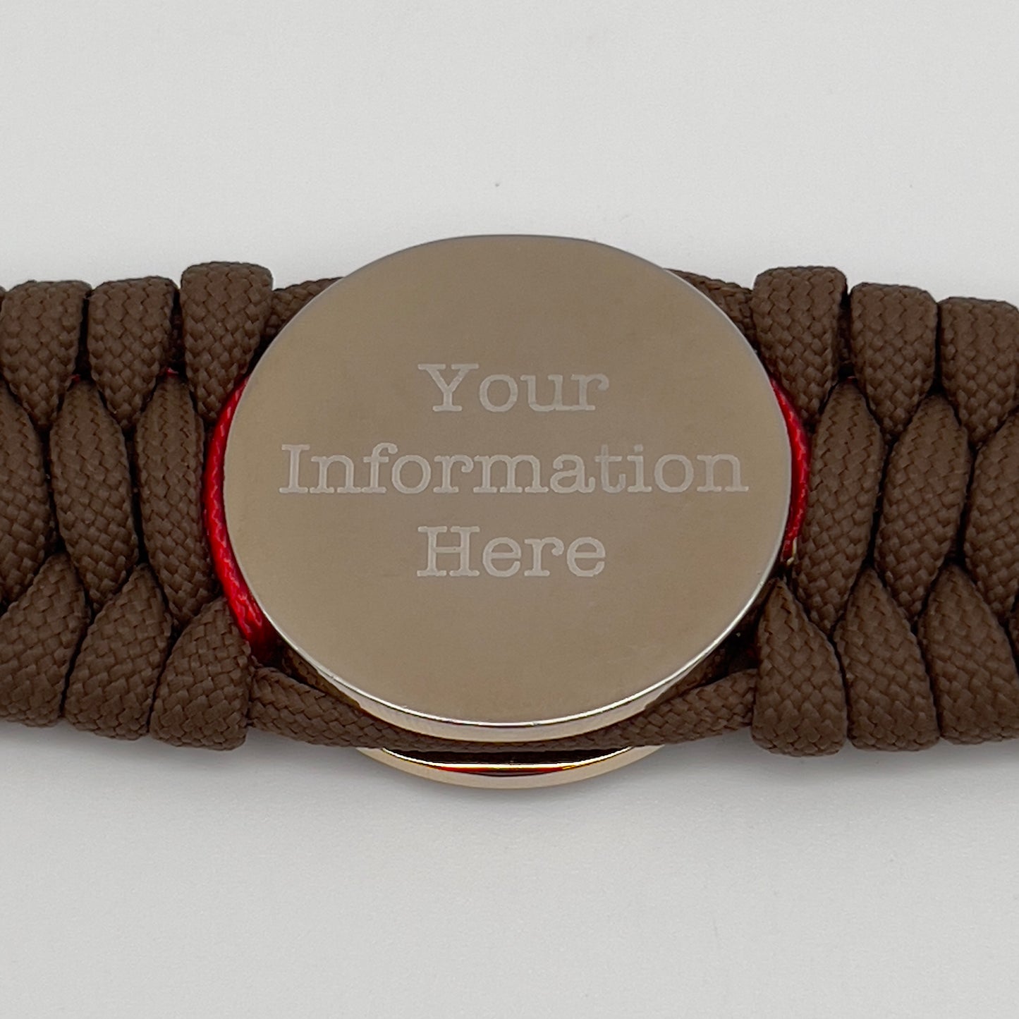 Thick and comfortable braided United States Marine Corps bracelet featuring a 24K gold and silver plated USMC officer Eagle Globe and Anchor medallion, a Cobra style tactical buckle and woven with Coyote Brown 550 paracord and Imperial Red and gold micro cord.