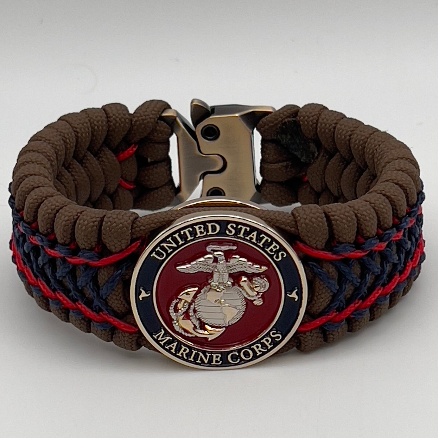 Thick and comfortable braided United States Marine Corps bracelet featuring a 24K gold and silver plated USMC officer Eagle Globe and Anchor medallion, a Cobra style tactical buckle and woven with Coyote Brown 550 paracord and Imperial Red and Navy Blue micro cord.