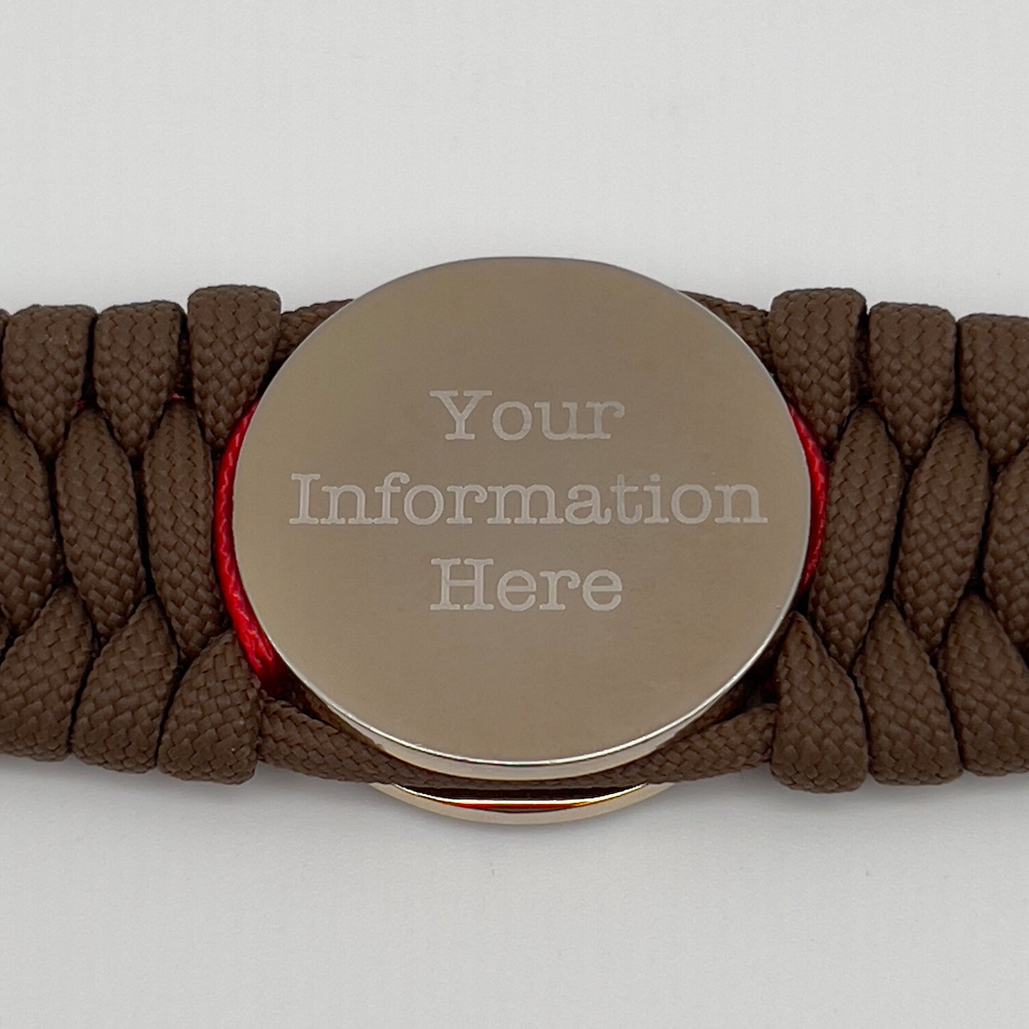 Thick and comfortable braided United States Marine Corps bracelet featuring a 24K gold and silver plated USMC officer Eagle Globe and Anchor medallion, a Cobra style tactical buckle and woven with Coyote Brown 550 paracord and Imperial Red and Navy Blue micro cord.